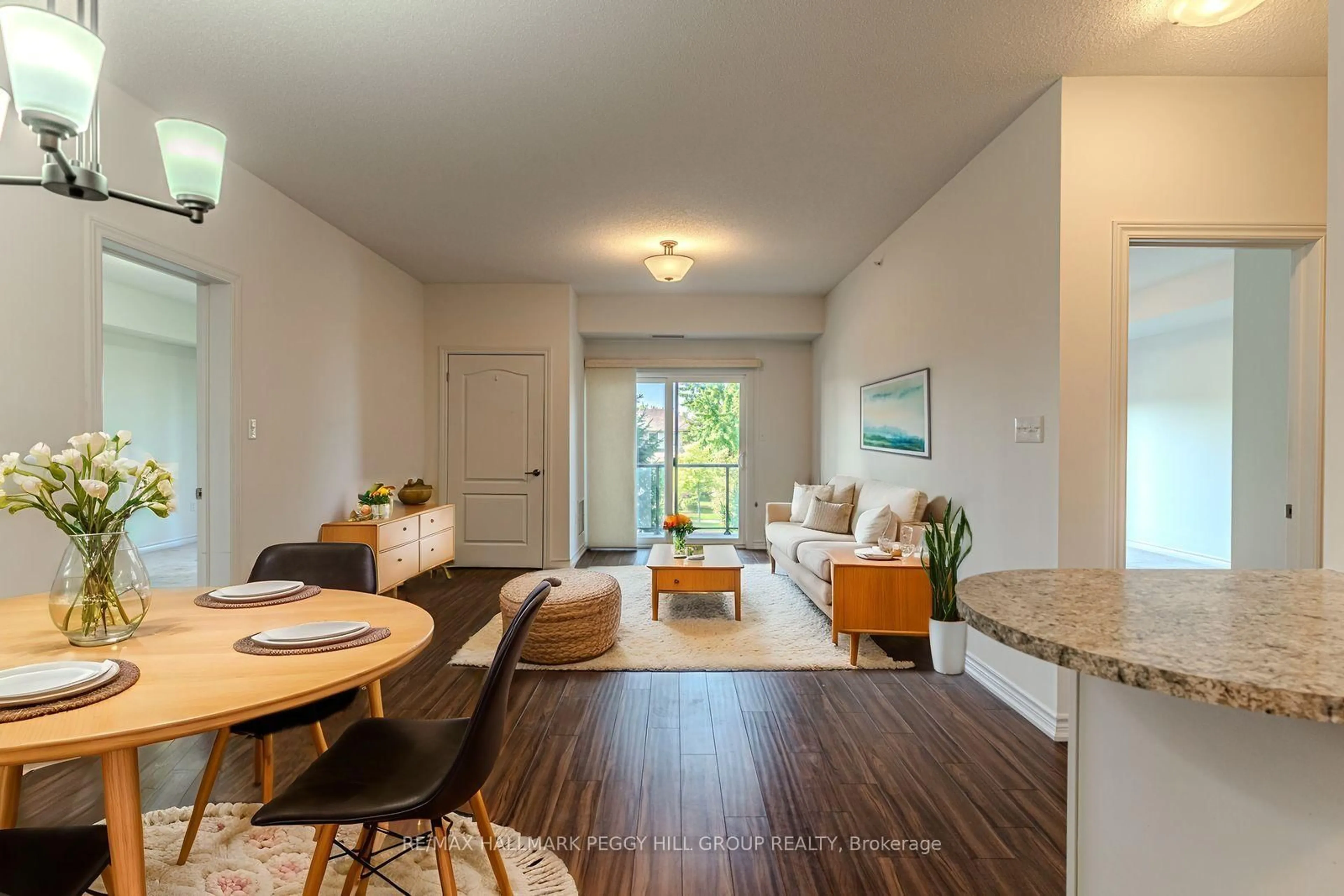 Living room with furniture, wood/laminate floor for 100 Dean Ave #110, Barrie Ontario L9J 0H1