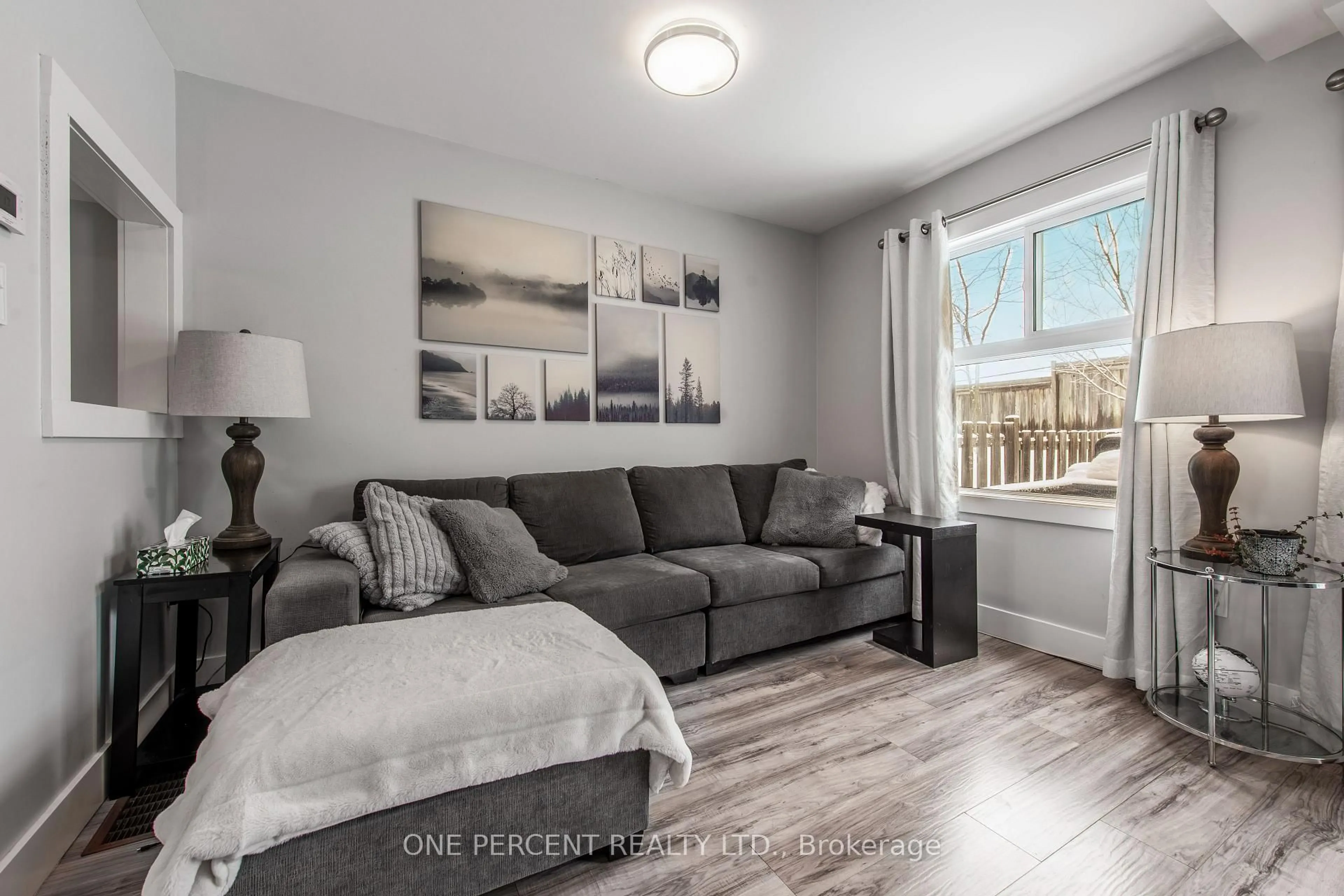 Living room with furniture, wood/laminate floor for 67 Hawthorne Cres, Barrie Ontario L4N 9Y8