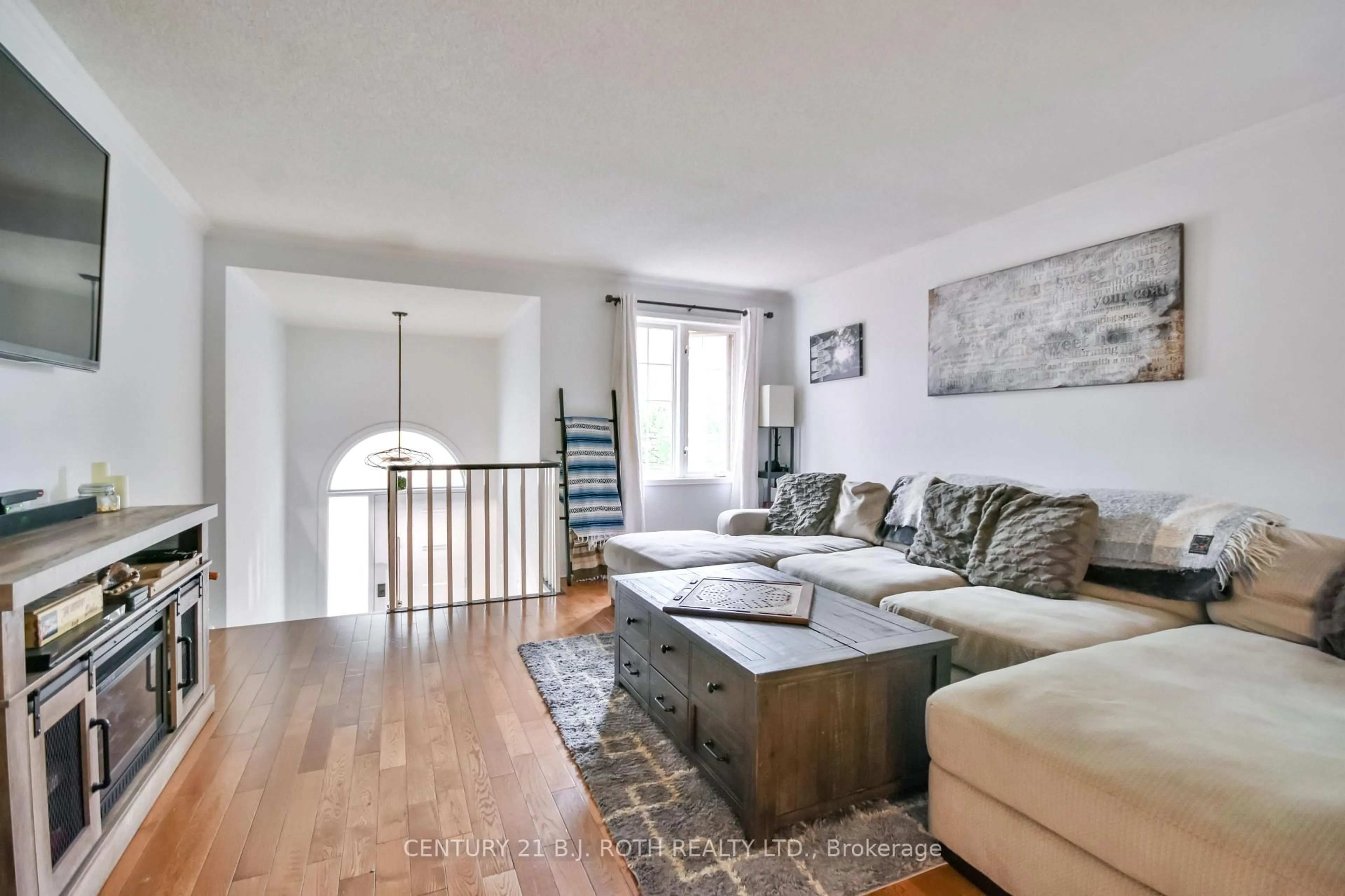 Living room with furniture, wood/laminate floor for 56 Monique Cres, Barrie Ontario L4M 6Y4