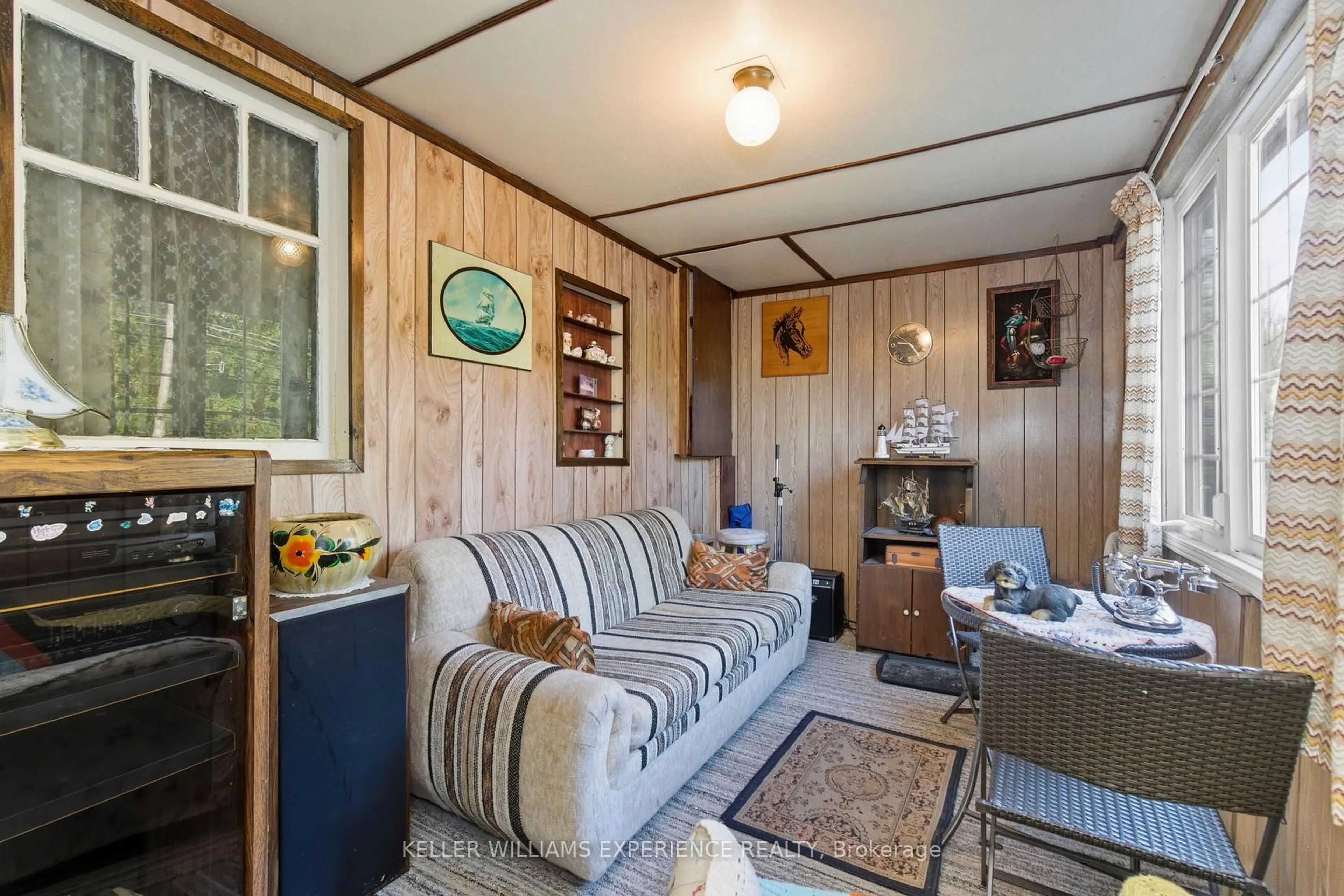 Living room with furniture, wood/laminate floor for 2007 Tiny Beaches Rd, Tiny Ontario L0L 1P1