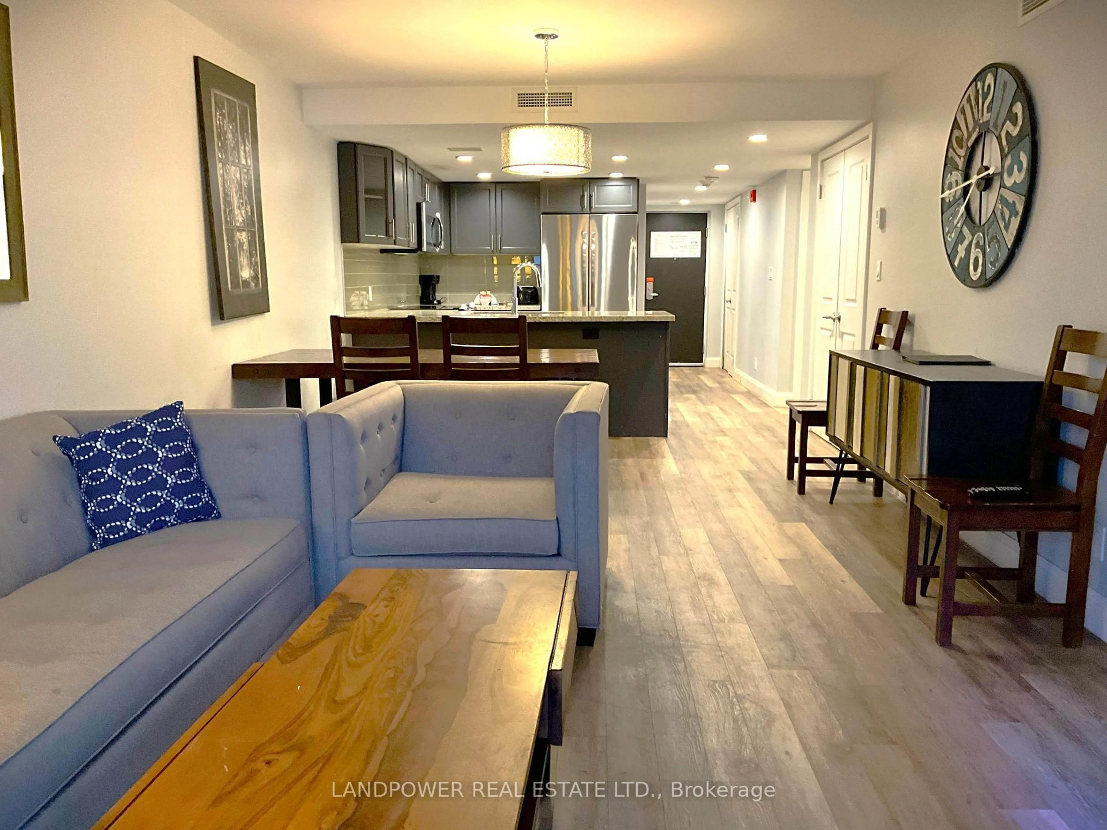 Living room with furniture, wood/laminate floor for 80 Horseshoe Blvd #101, Oro-Medonte Ontario L4M 4Y8