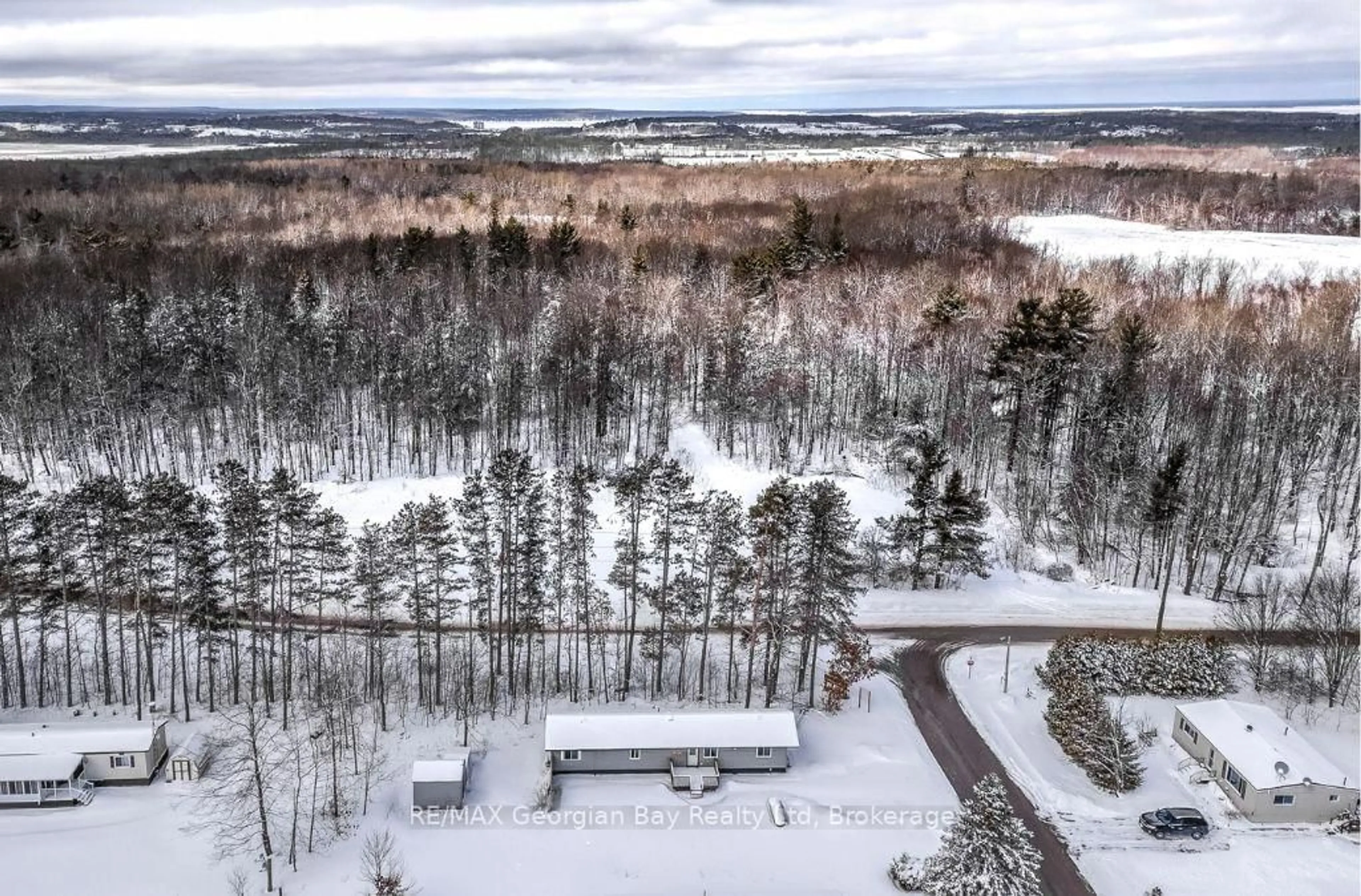 A pic from outside/outdoor area/front of a property/back of a property/a pic from drone, forest/trees view for 5263 Elliott Sdrd ##1, Tay Ontario L4R 4K3