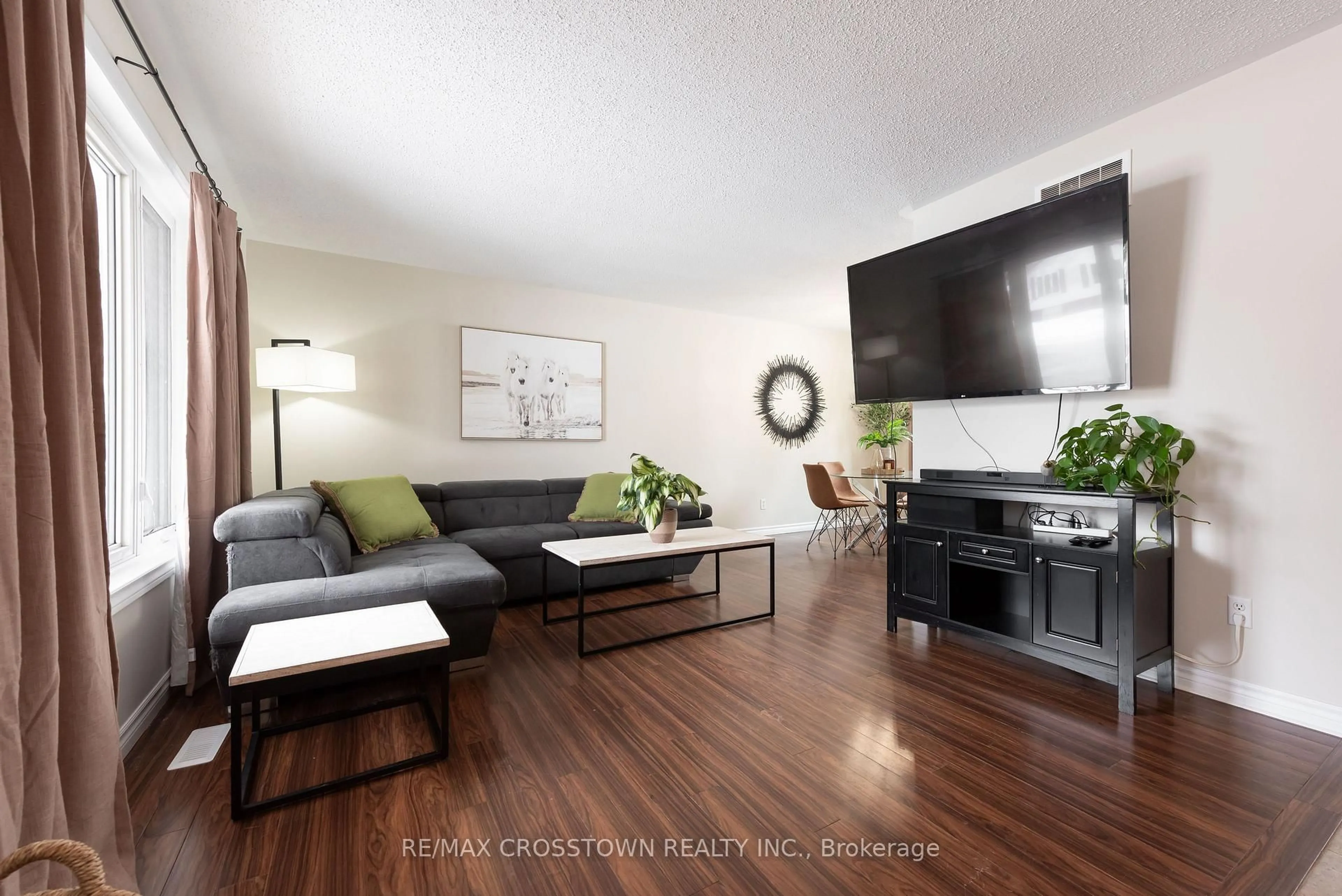 Living room with furniture, wood/laminate floor for 54 Foyston Park Circ, Springwater Ontario L0L 1Y0