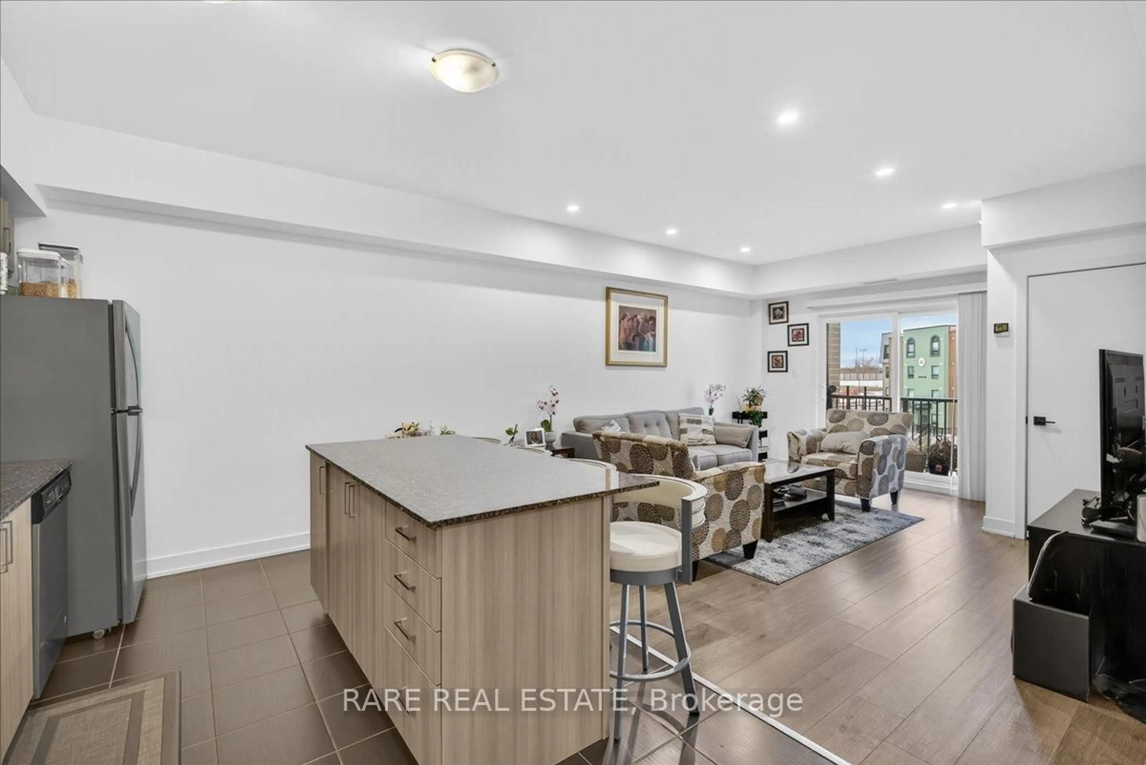 Open concept kitchen, wood/laminate floor for 5 Chef Lane #411, Barrie Ontario L9J 0J8