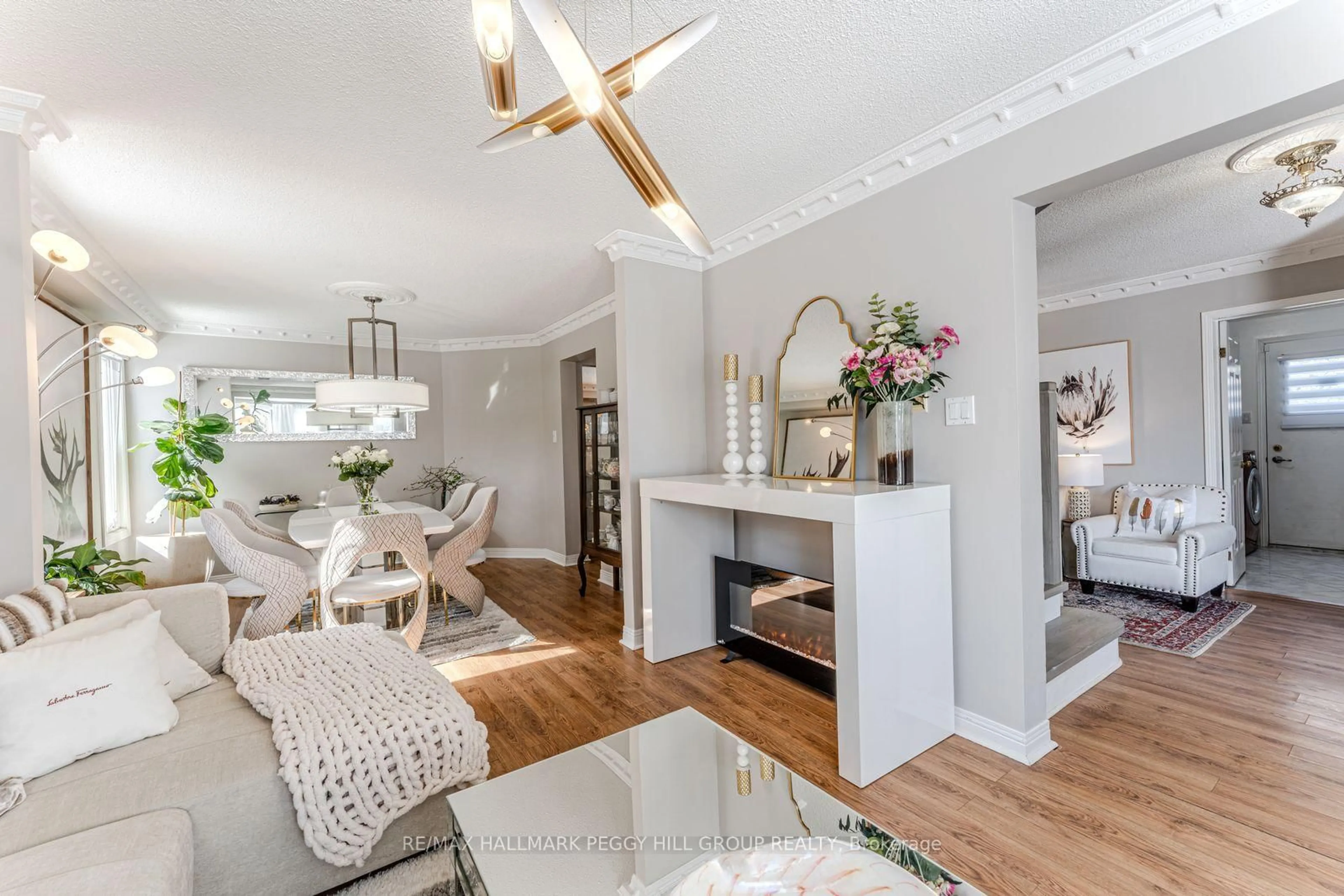 Living room with furniture, wood/laminate floor for 153 Browning Tr, Barrie Ontario L4N 6R2