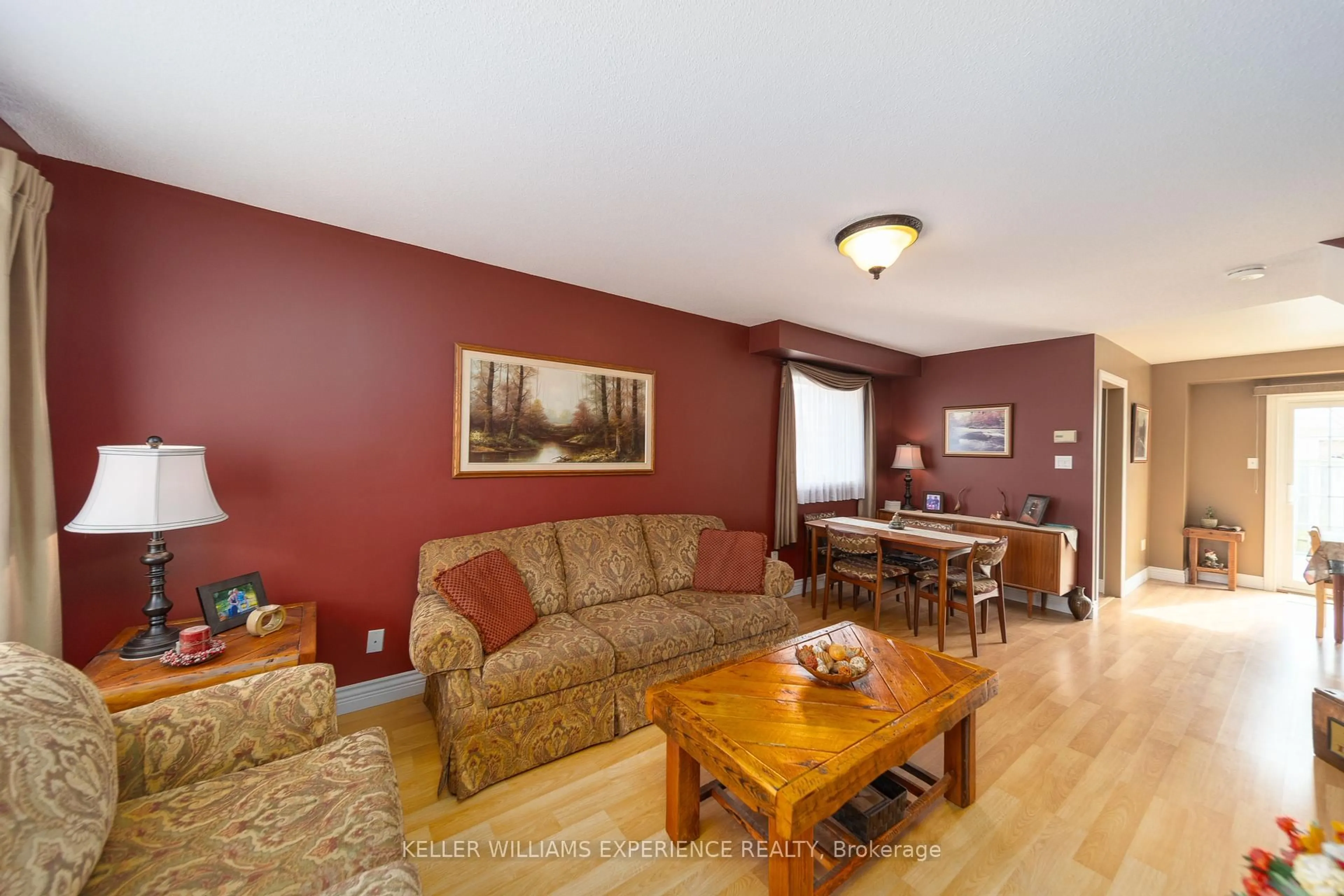 Living room with furniture, wood/laminate floor for 48 Basswood Dr, Barrie Ontario L4N 9P2