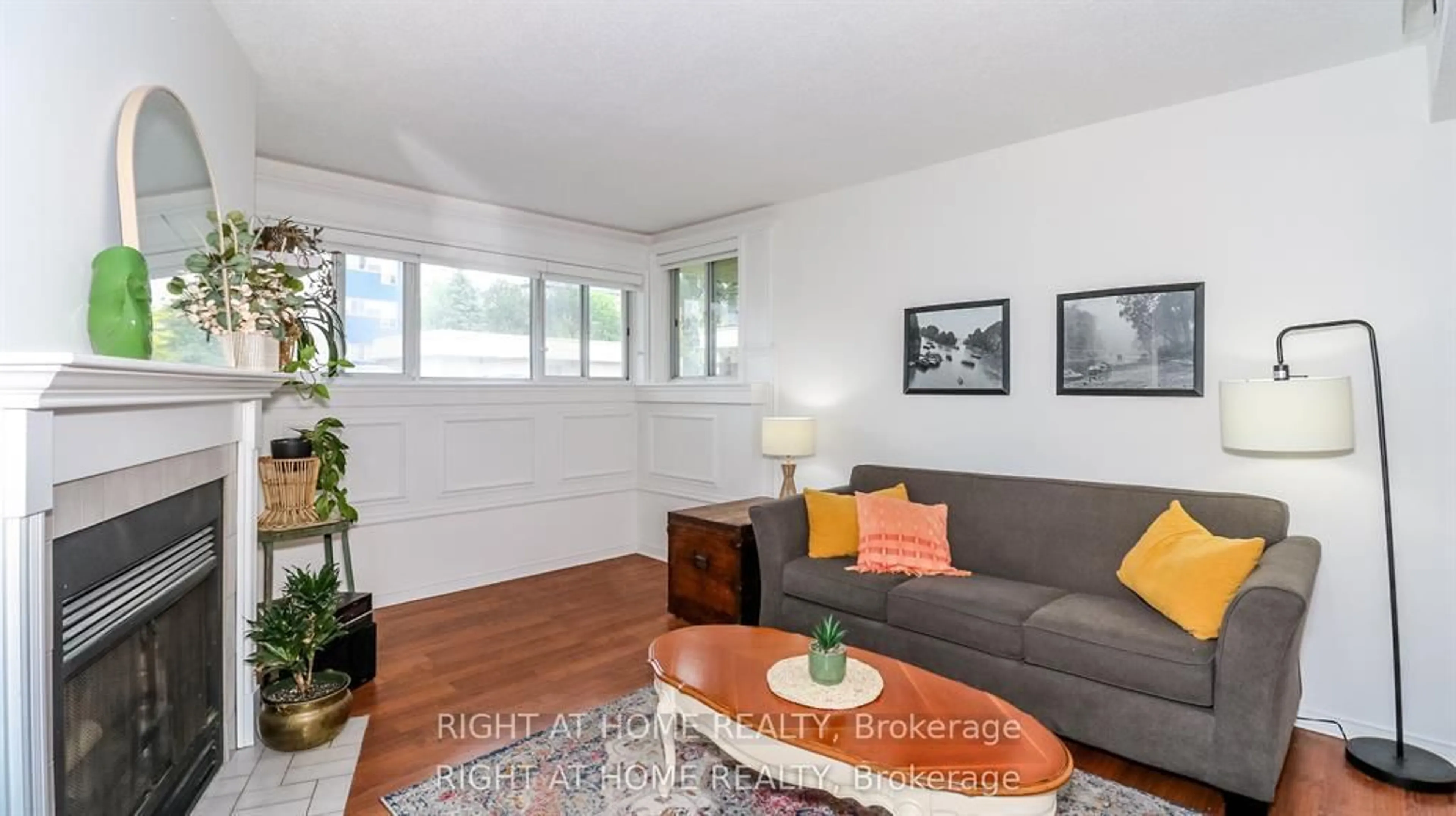 Living room with furniture, wood/laminate floor for 126 Bell Farm Rd #113, Barrie Ontario L4M 6J3