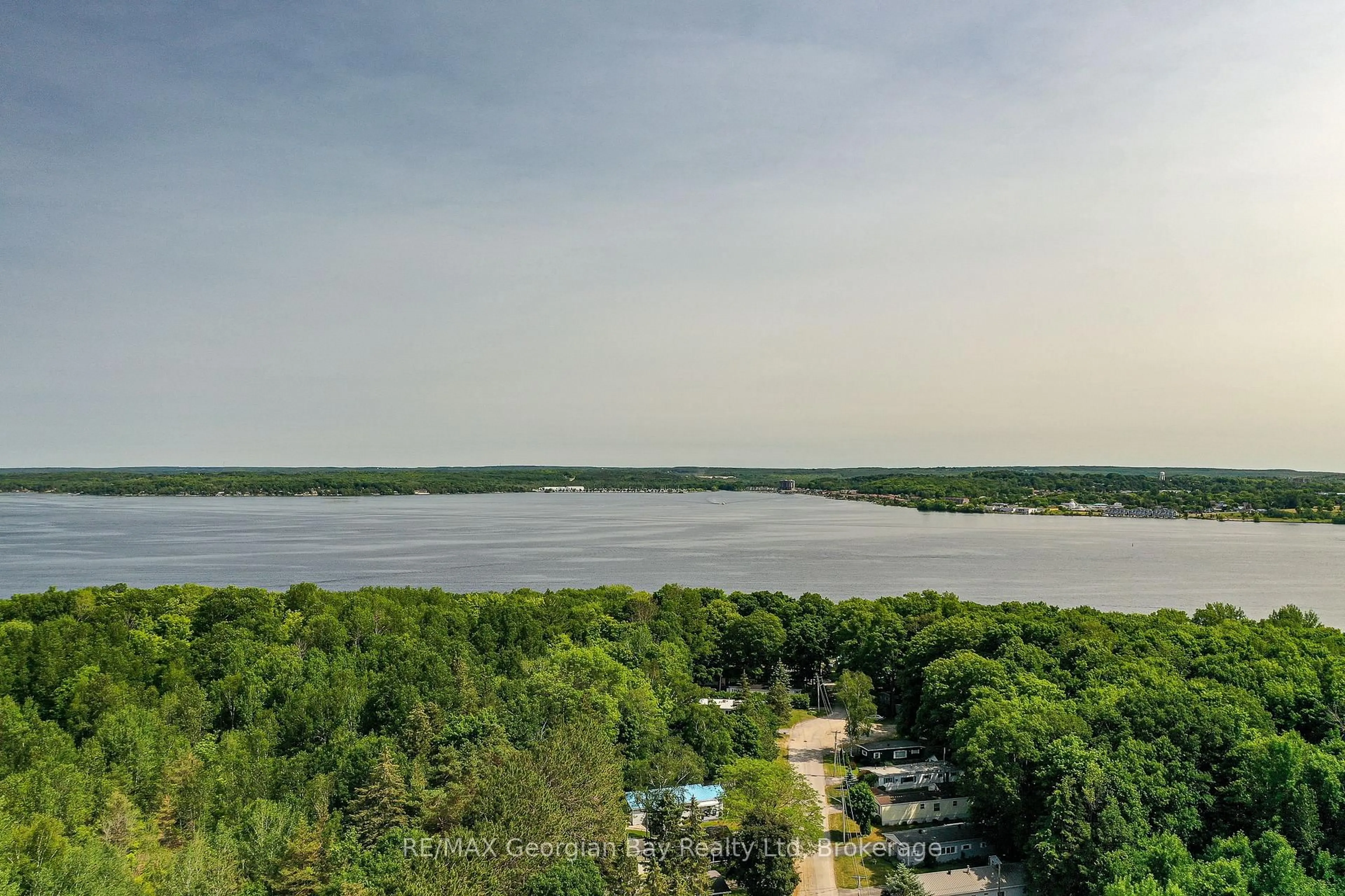 A pic from outside/outdoor area/front of a property/back of a property/a pic from drone, water/lake/river/ocean view for 525 Midland Point Rd #63, Midland Ontario L4R 5G1