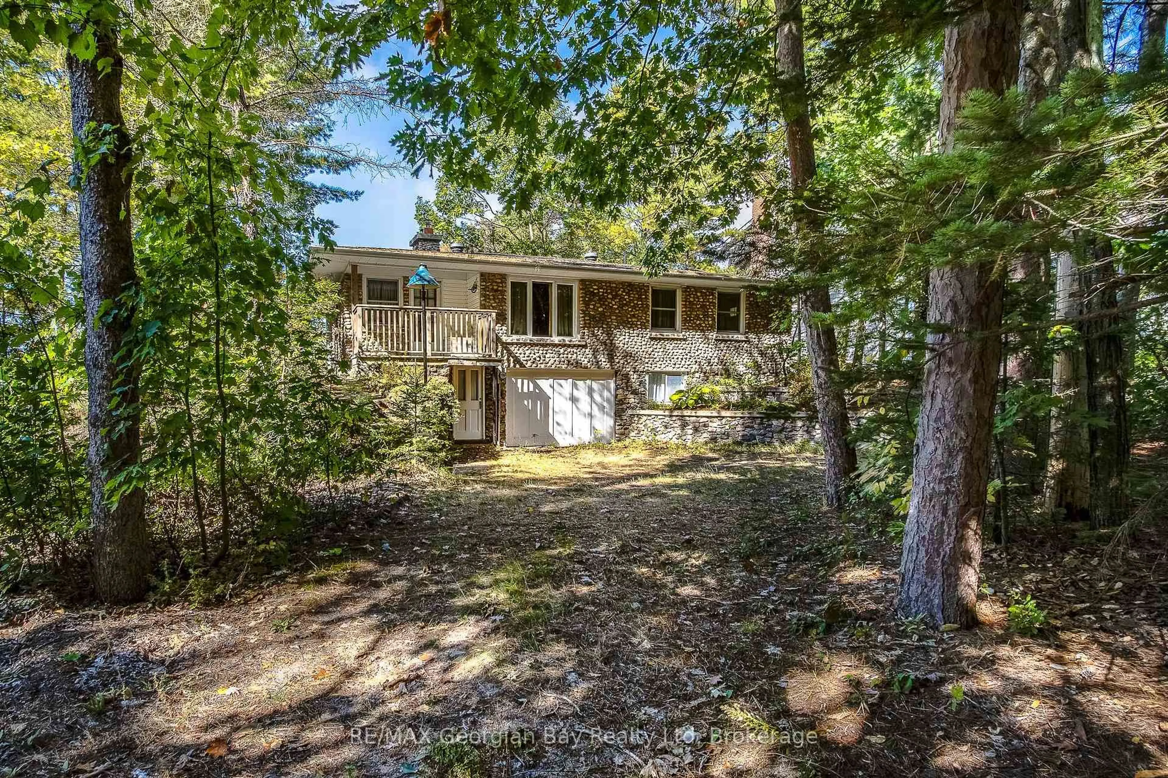 A pic from outside/outdoor area/front of a property/back of a property/a pic from drone, forest/trees view for 750 Tiny Beaches Rd, Tiny Ontario L0L 2T0