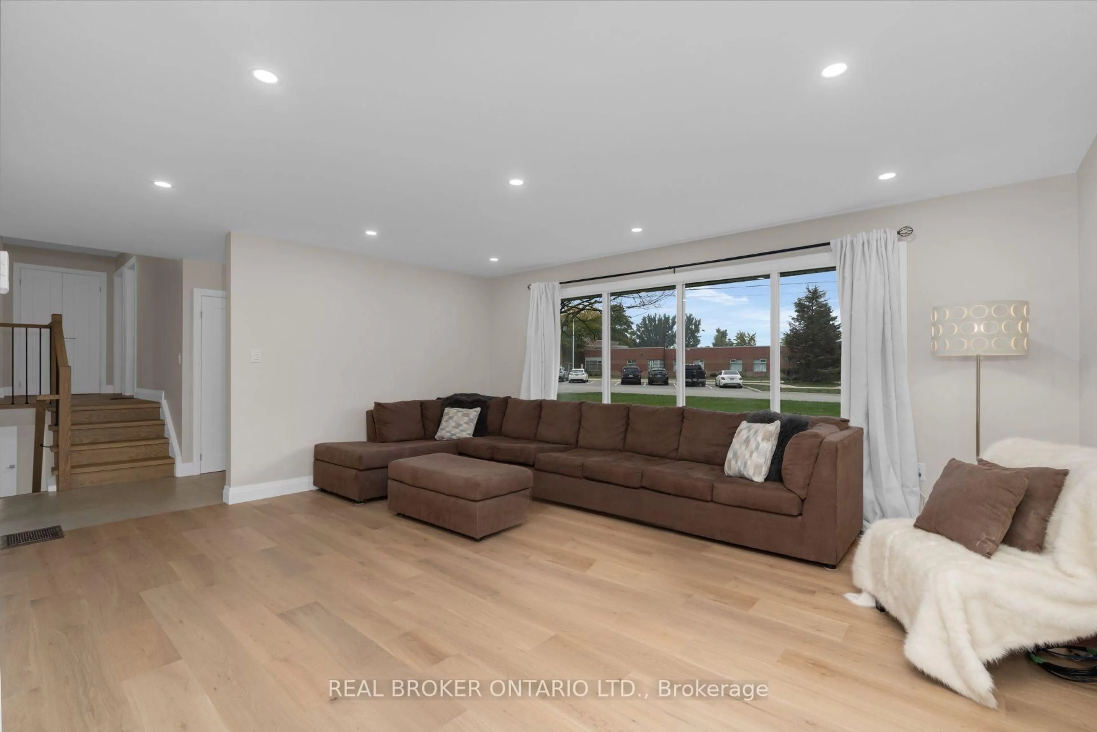 Living room with furniture, wood/laminate floor for 17 Locke Ave, Clearview Ontario L0M 1S0