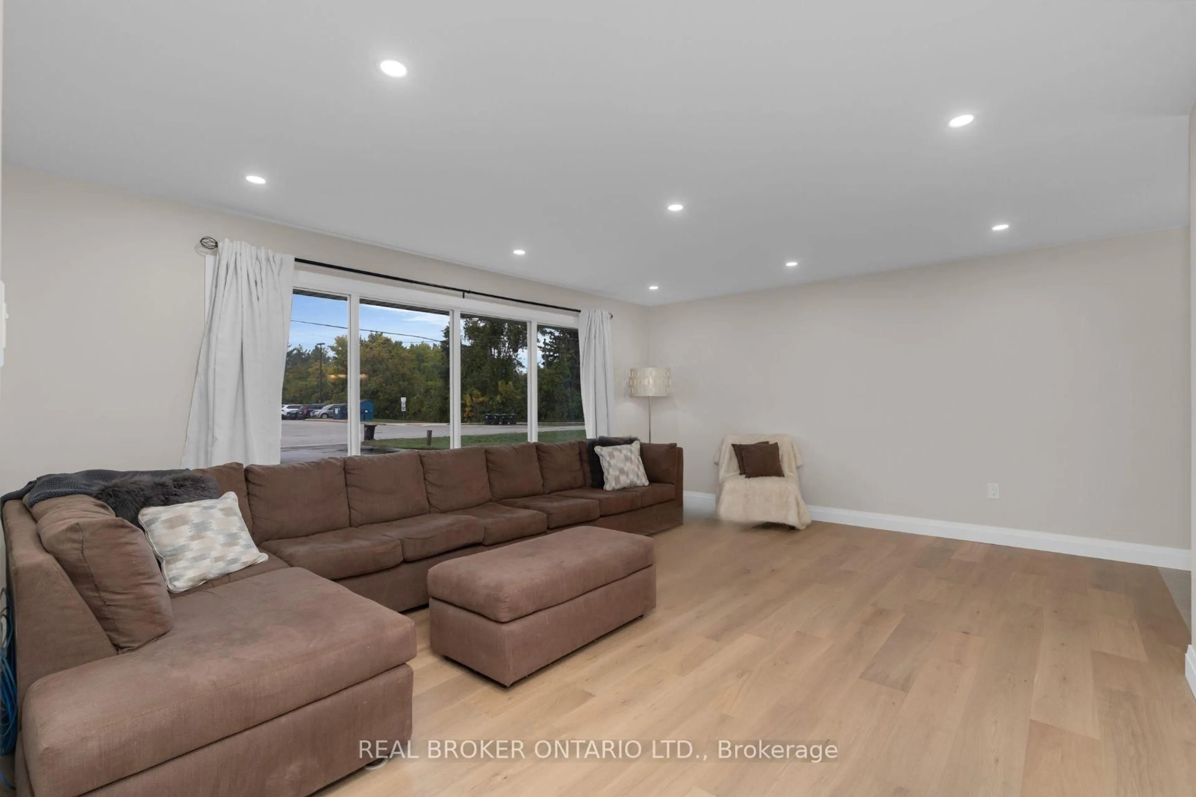 Living room with furniture, wood/laminate floor for 17 Locke Ave, Clearview Ontario L0M 1S0