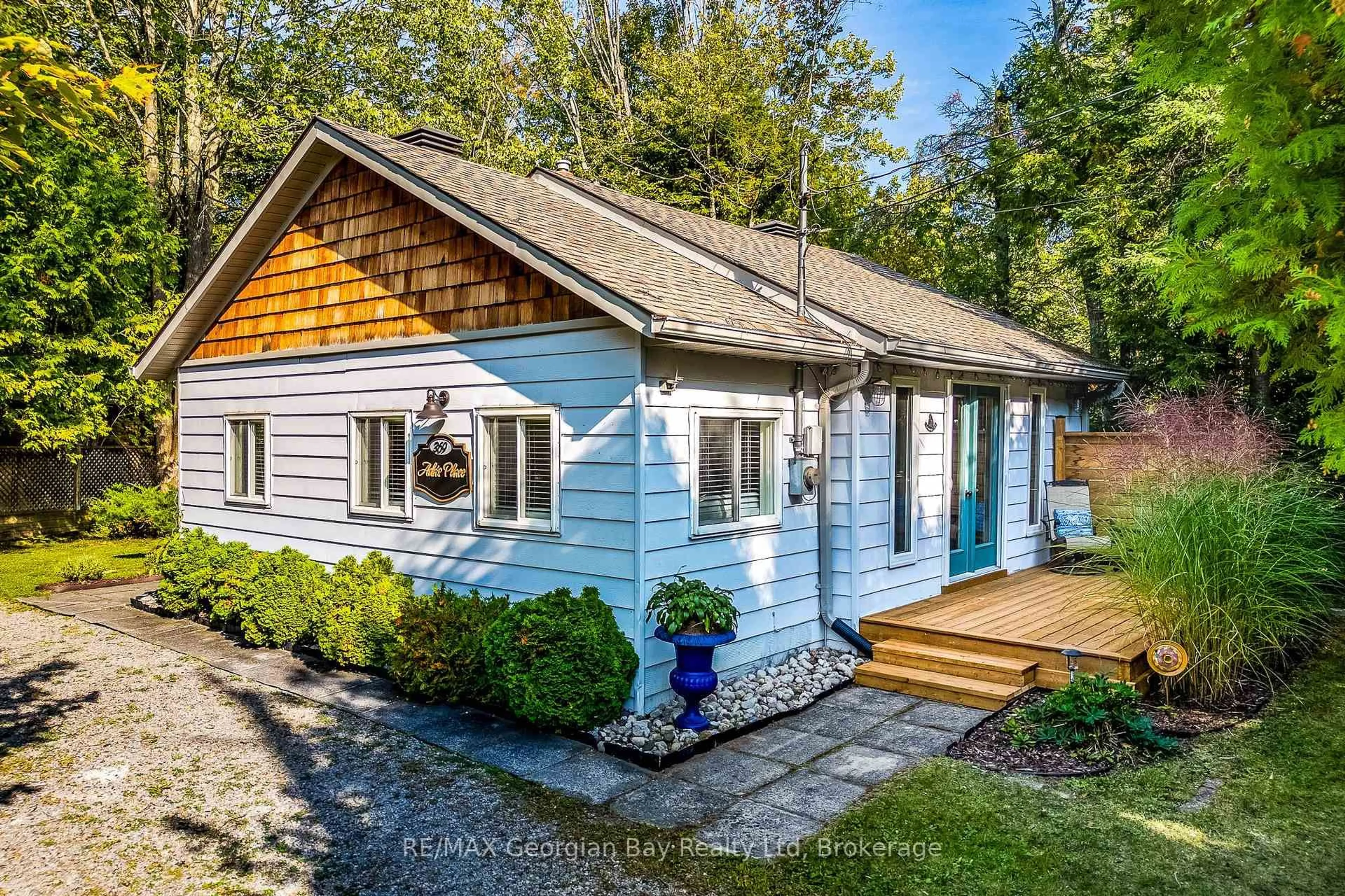 Home with vinyl exterior material, street for 369 Tiny Beaches Rd, Tiny Ontario L0L 2J0