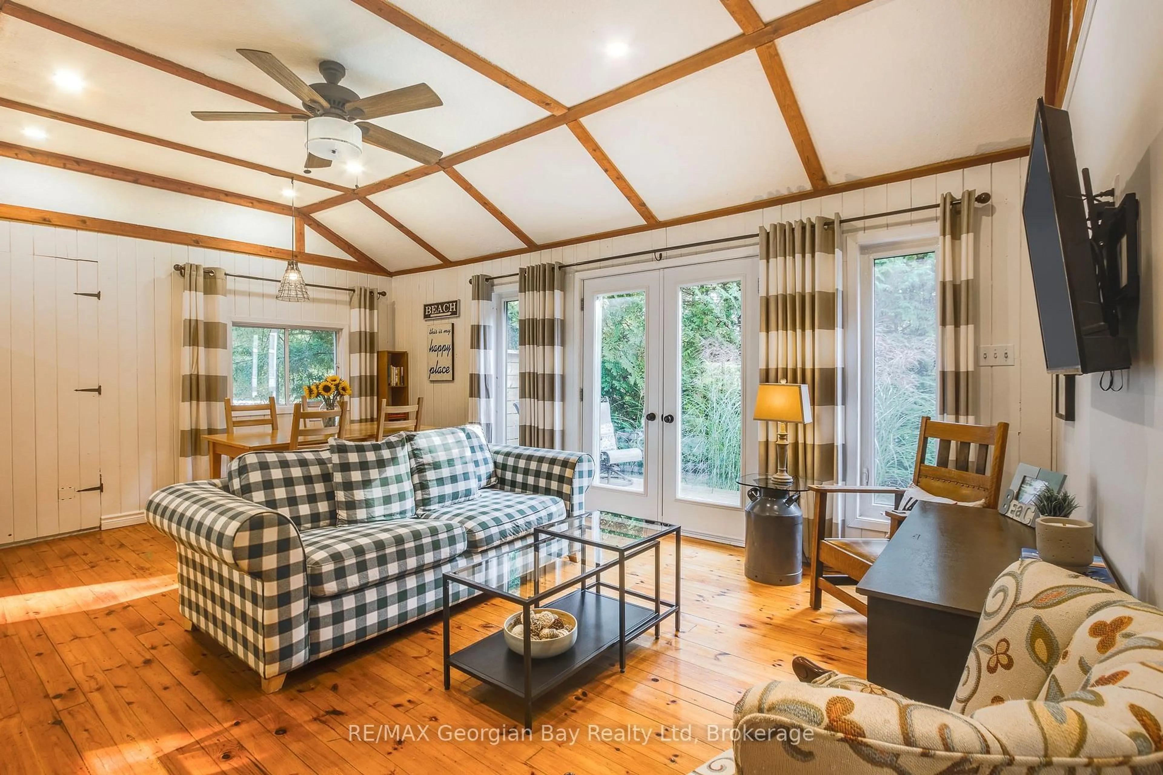 Living room with furniture, wood/laminate floor for 369 Tiny Beaches Rd, Tiny Ontario L0L 2J0