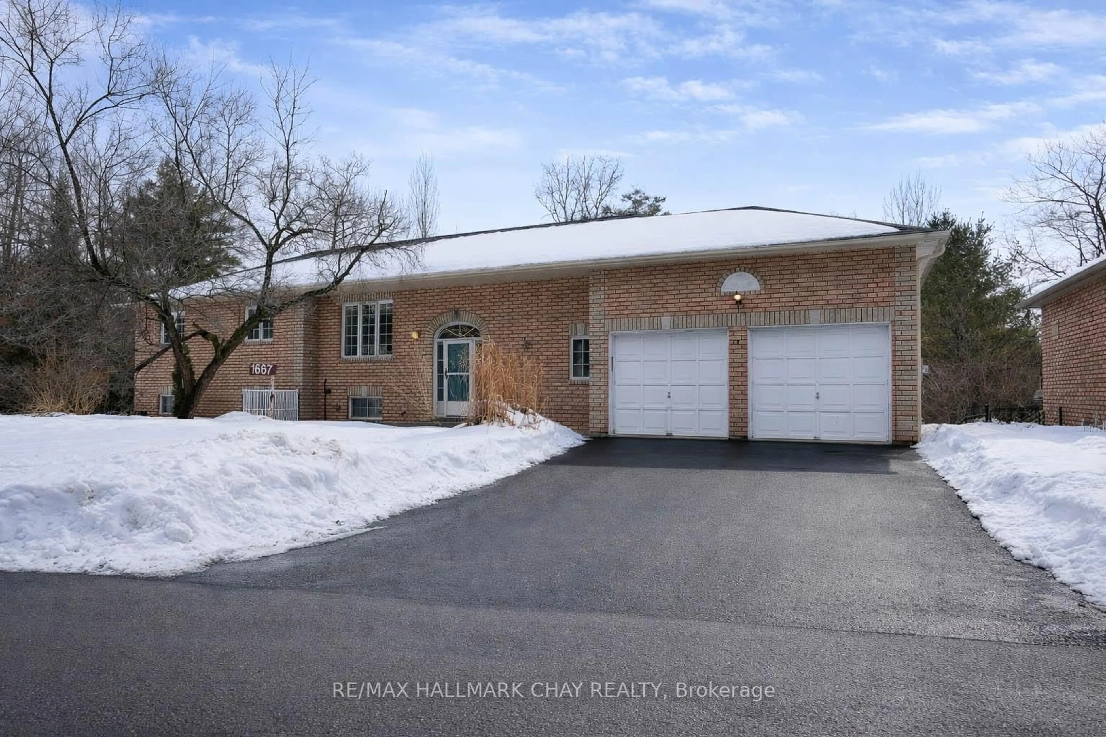 Home with brick exterior material, street for 1667 Tiny Beaches Rd, Tiny Ontario L0L 1P0
