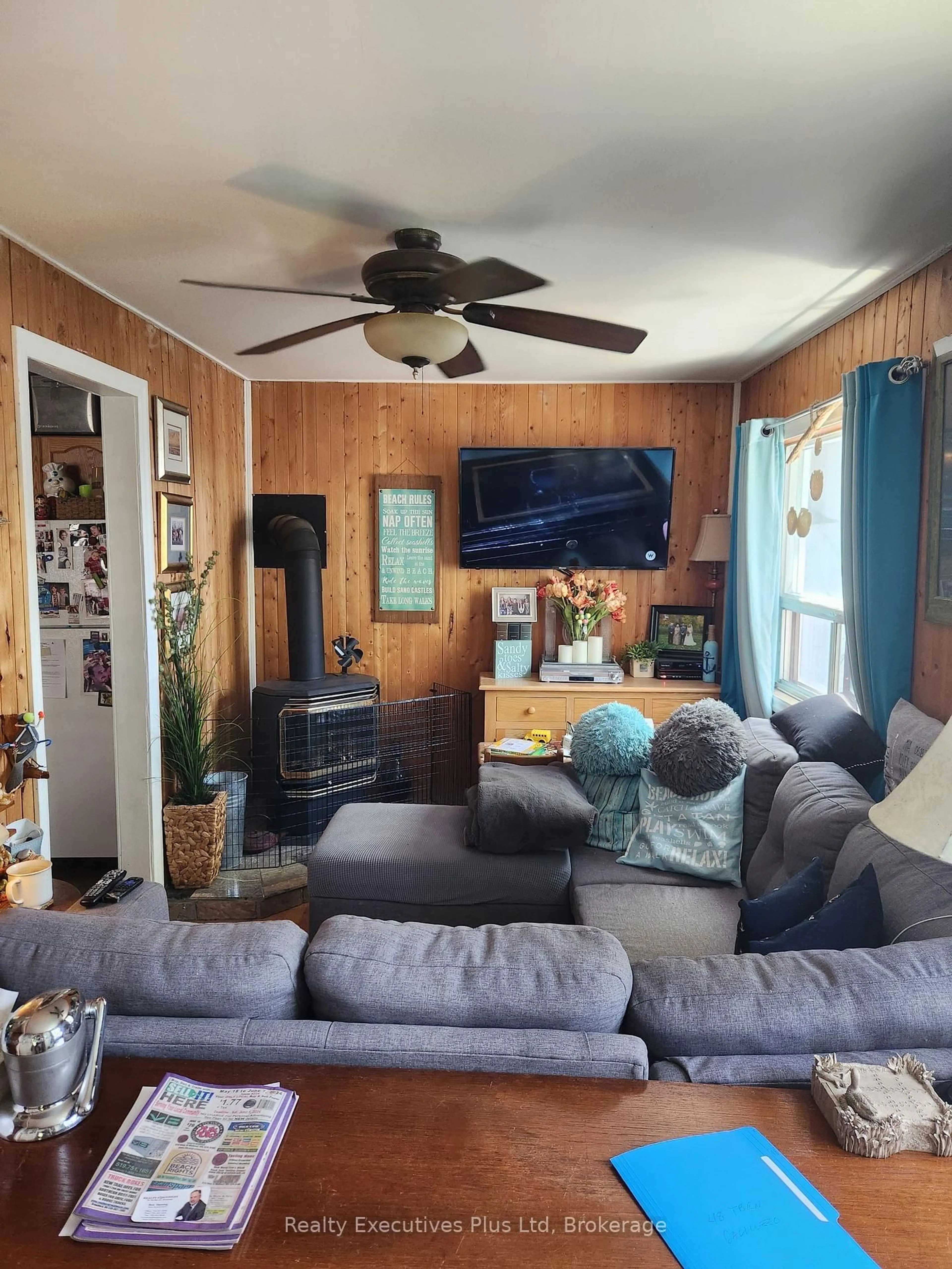 Living room with furniture, wood/laminate floor for 48 Tiny Beaches Rd, Tiny Ontario L0L 2J0