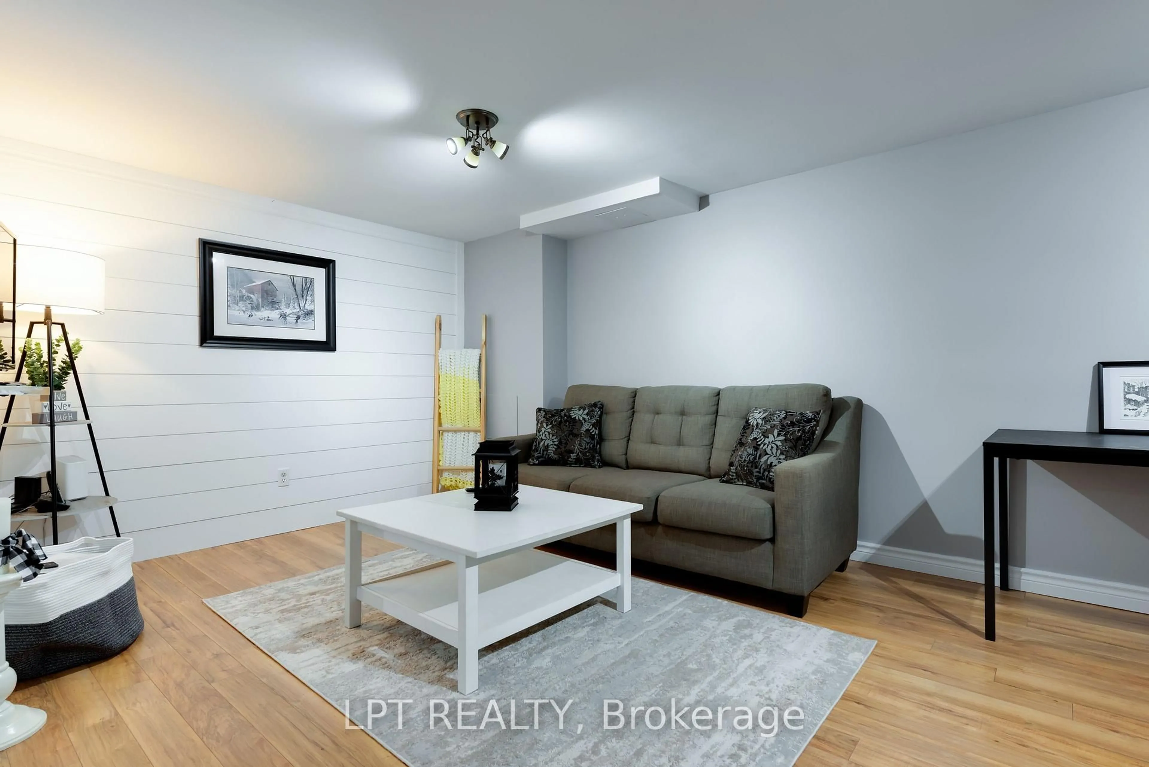 Living room with furniture, wood/laminate floor for 34 Cedar Creek Rd, Springwater Ontario L9X 0P5