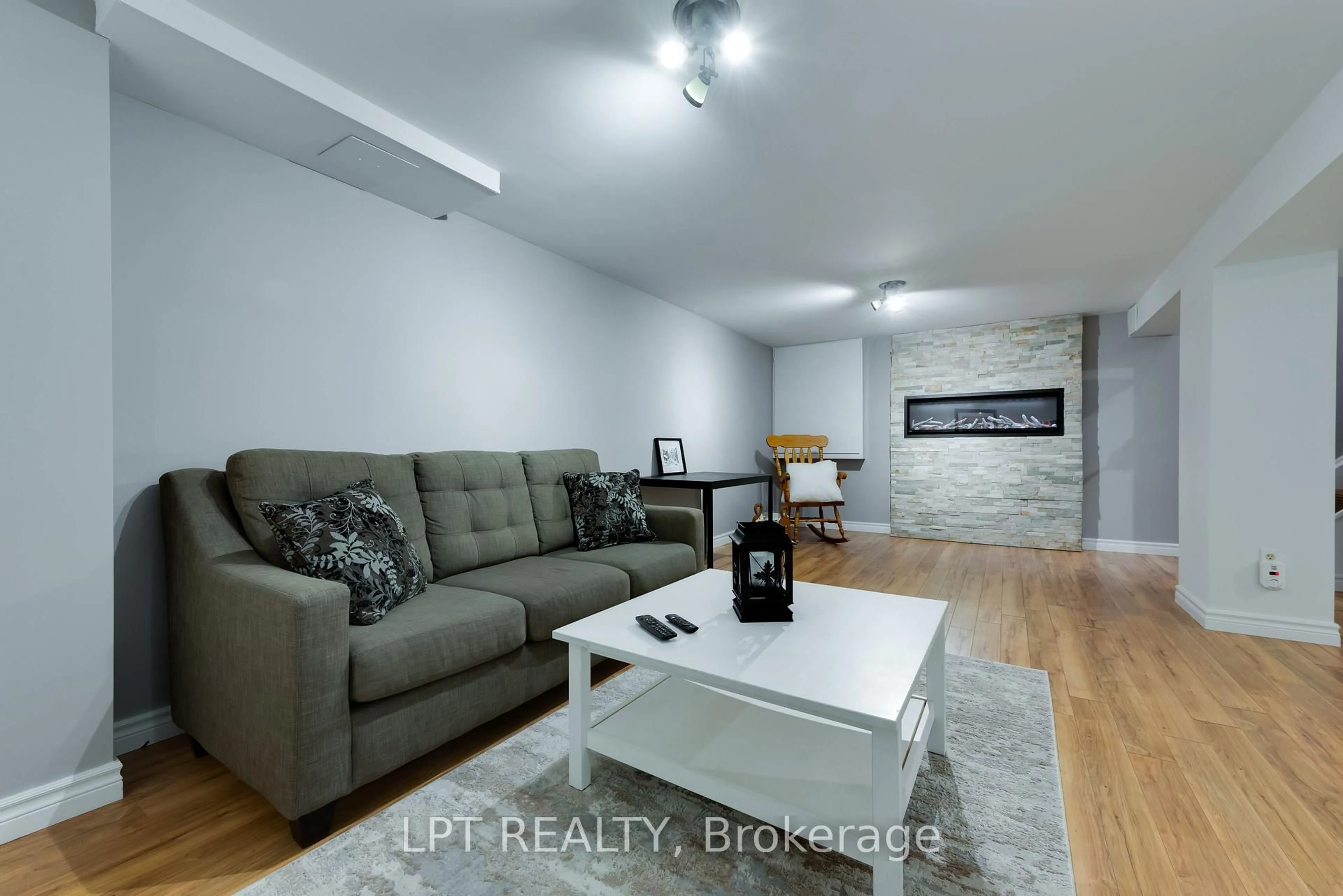 Living room with furniture, wood/laminate floor for 34 Cedar Creek Rd, Springwater Ontario L9X 0P5
