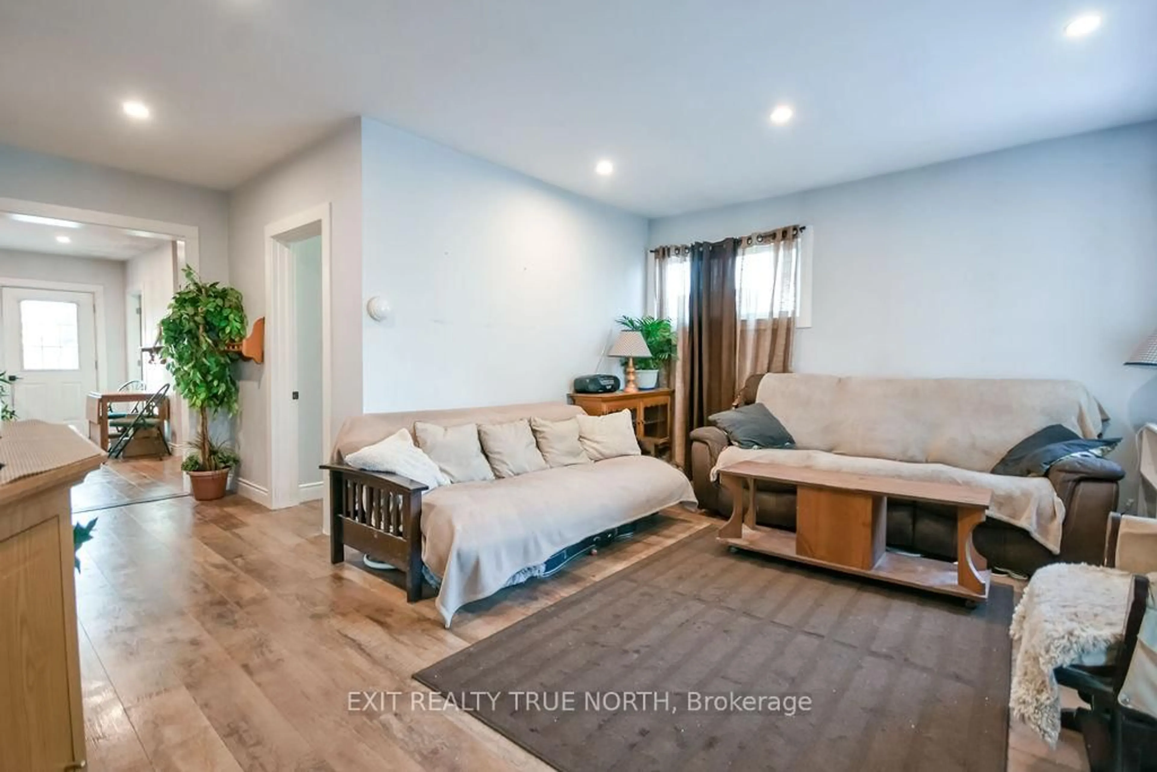 Living room with furniture, wood/laminate floor for 125 Queen St, Springwater Ontario L0L 1P0