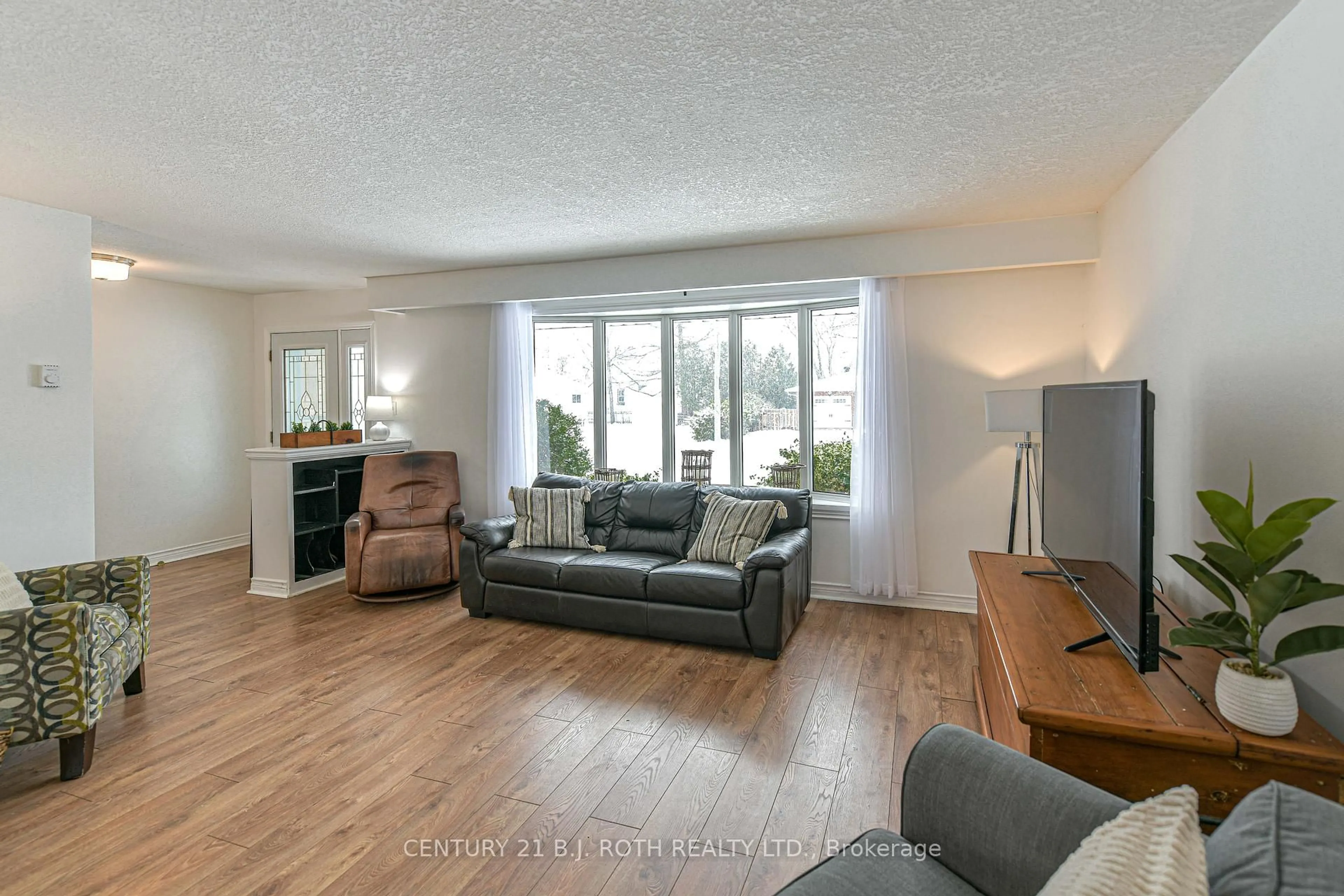 Living room with furniture, wood/laminate floor for 201 Point St, Clearview Ontario L0M 1S0