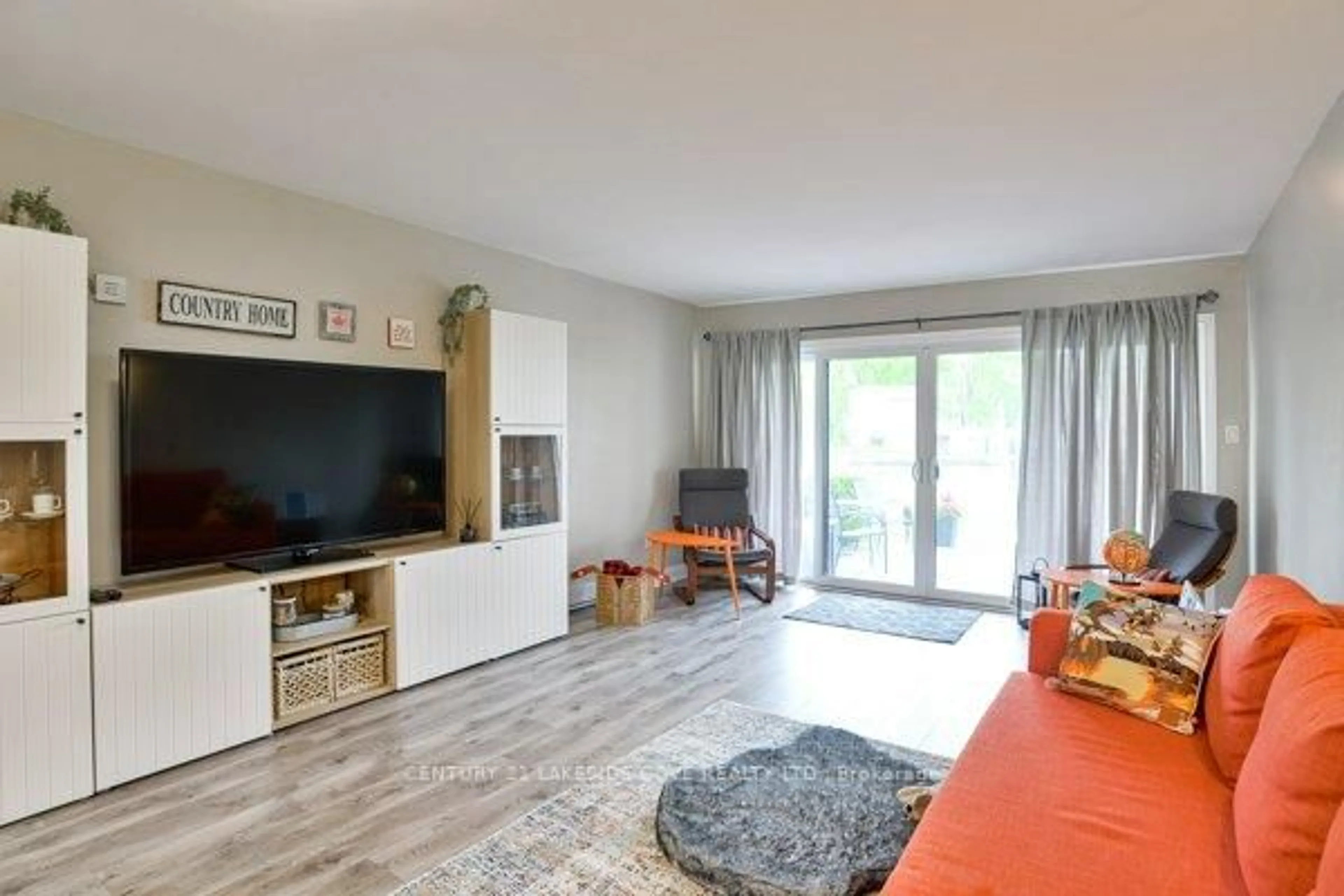 Living room with furniture, wood/laminate floor for 1 Paradise Blvd #Unit 14, Ramara Ontario L0K 1B0