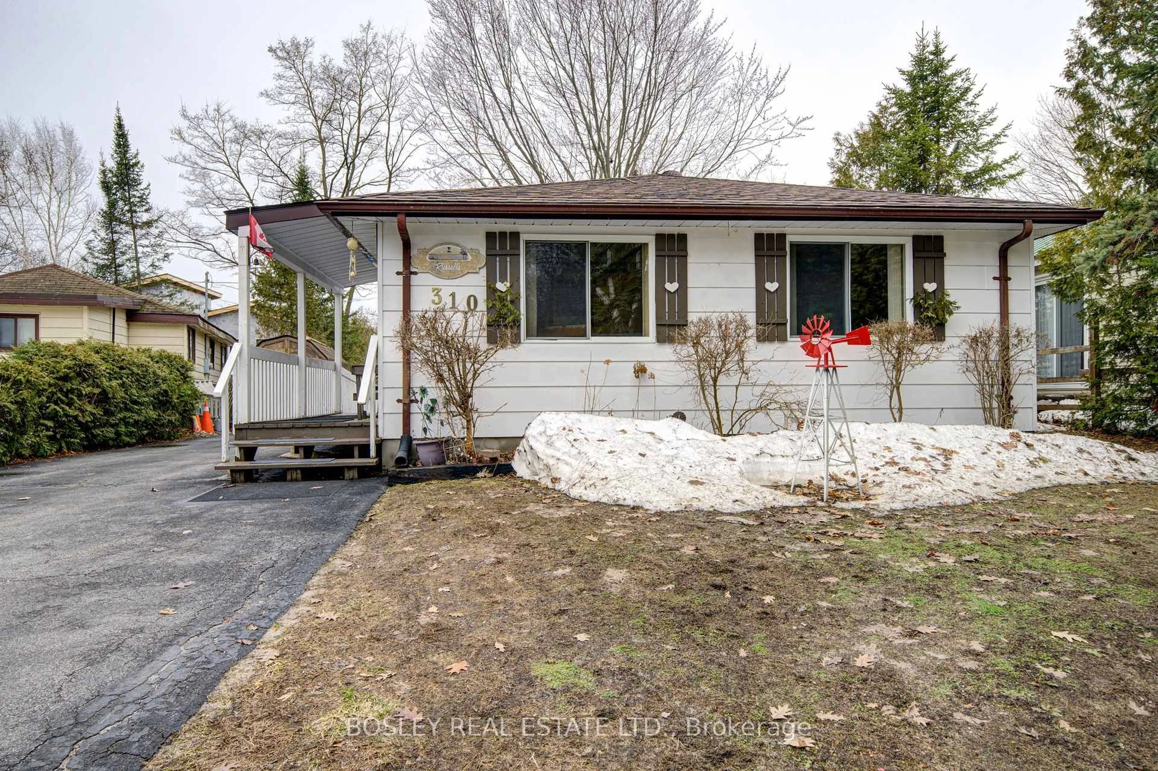 Home with vinyl exterior material, street for 310 Tiny Beaches Rd, Tiny Ontario L0L 2J0