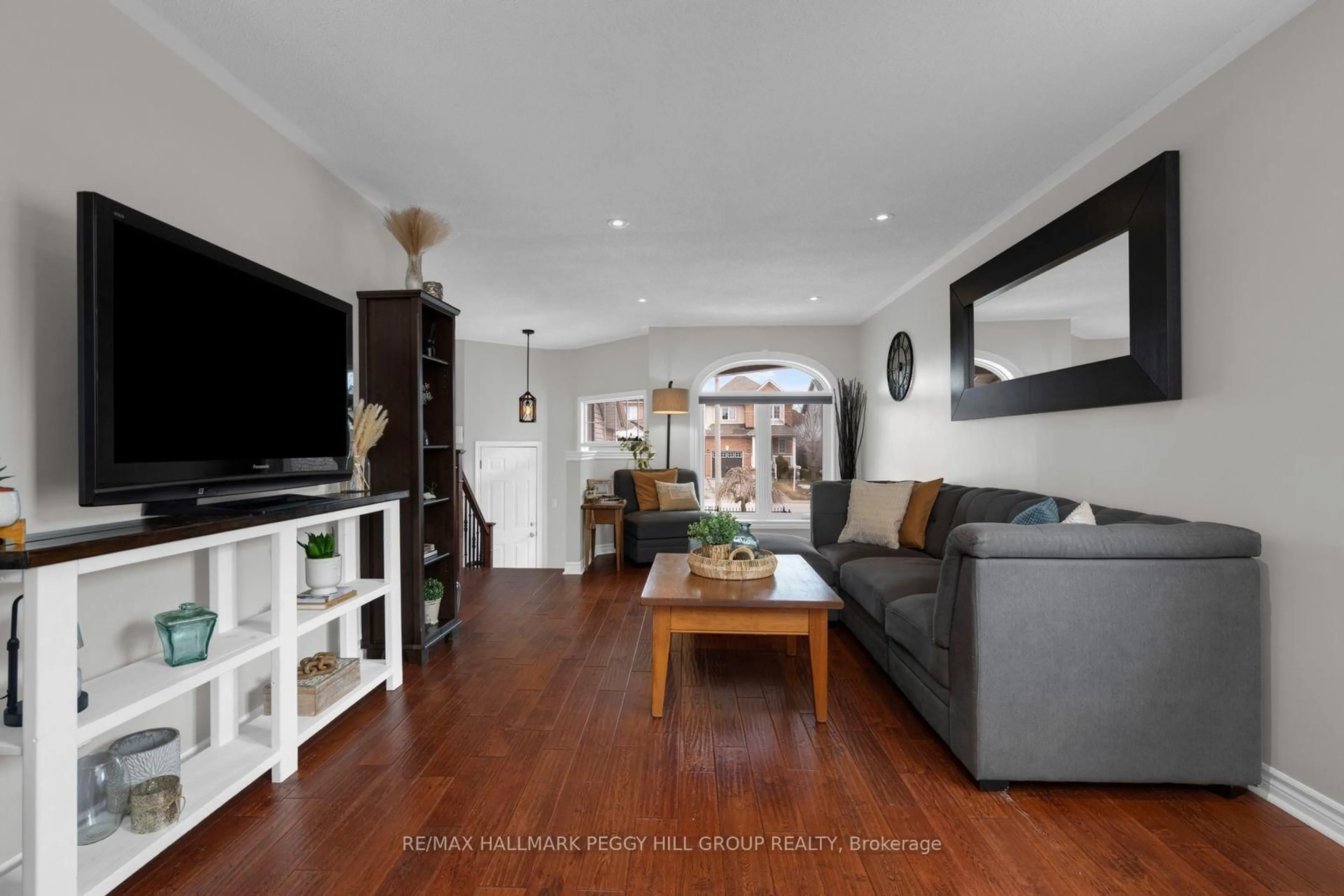 Living room with furniture, wood/laminate floor for 64A Bird St, Barrie Ontario L4N 0X3