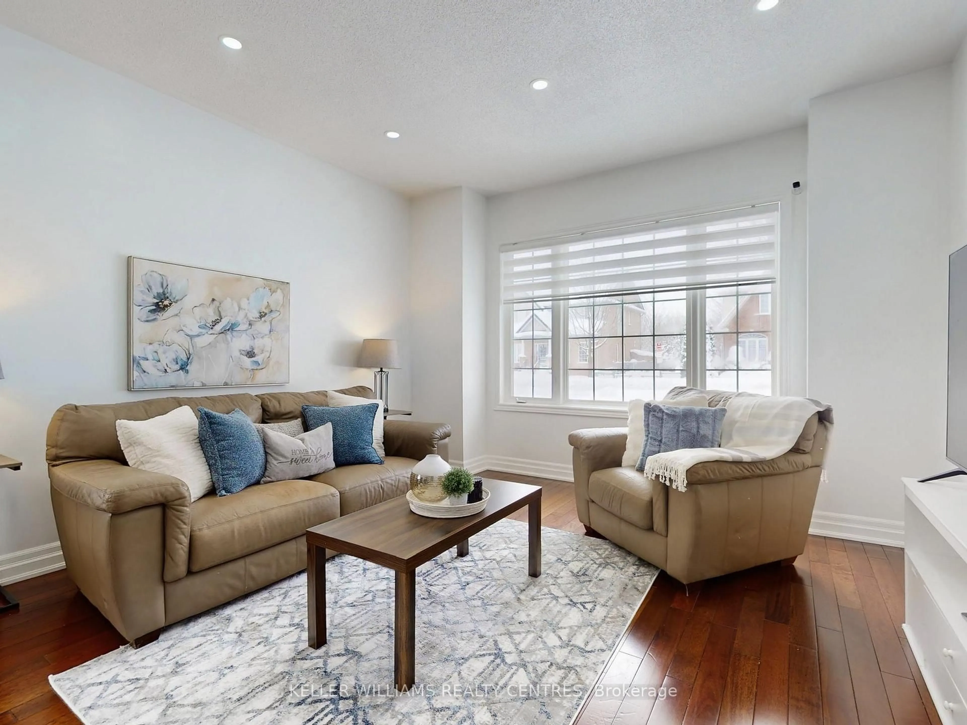 Living room with furniture, wood/laminate floor for 19 Thrushwood Dr, Barrie Ontario L4N 0Z1