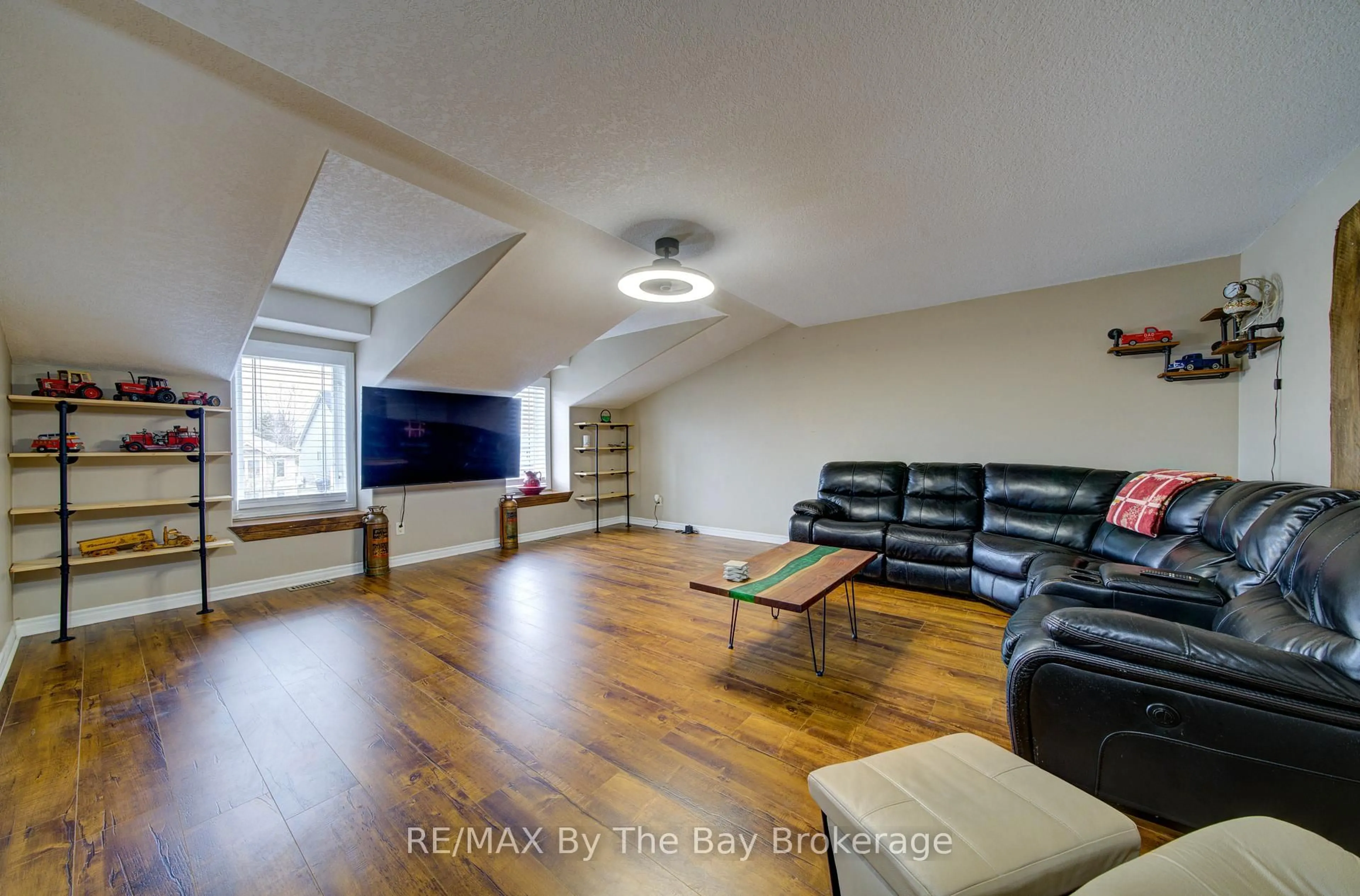 Living room with furniture, wood/laminate floor for 229 Atkinson St, Clearview Ontario L0M 1S0