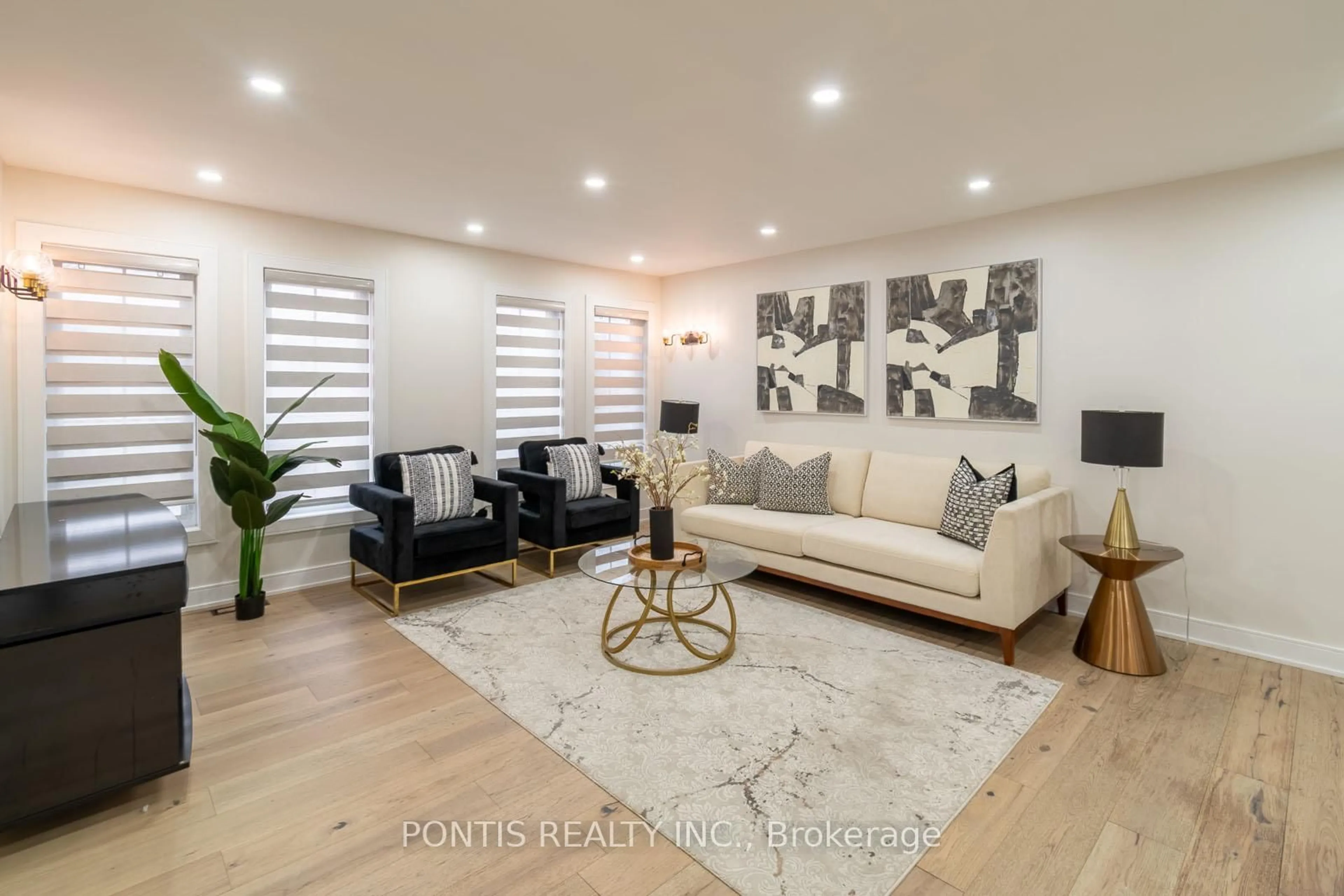 Living room with furniture, wood/laminate floor for 38 Kempenfelt Dr, Barrie Ontario L4M 1B9