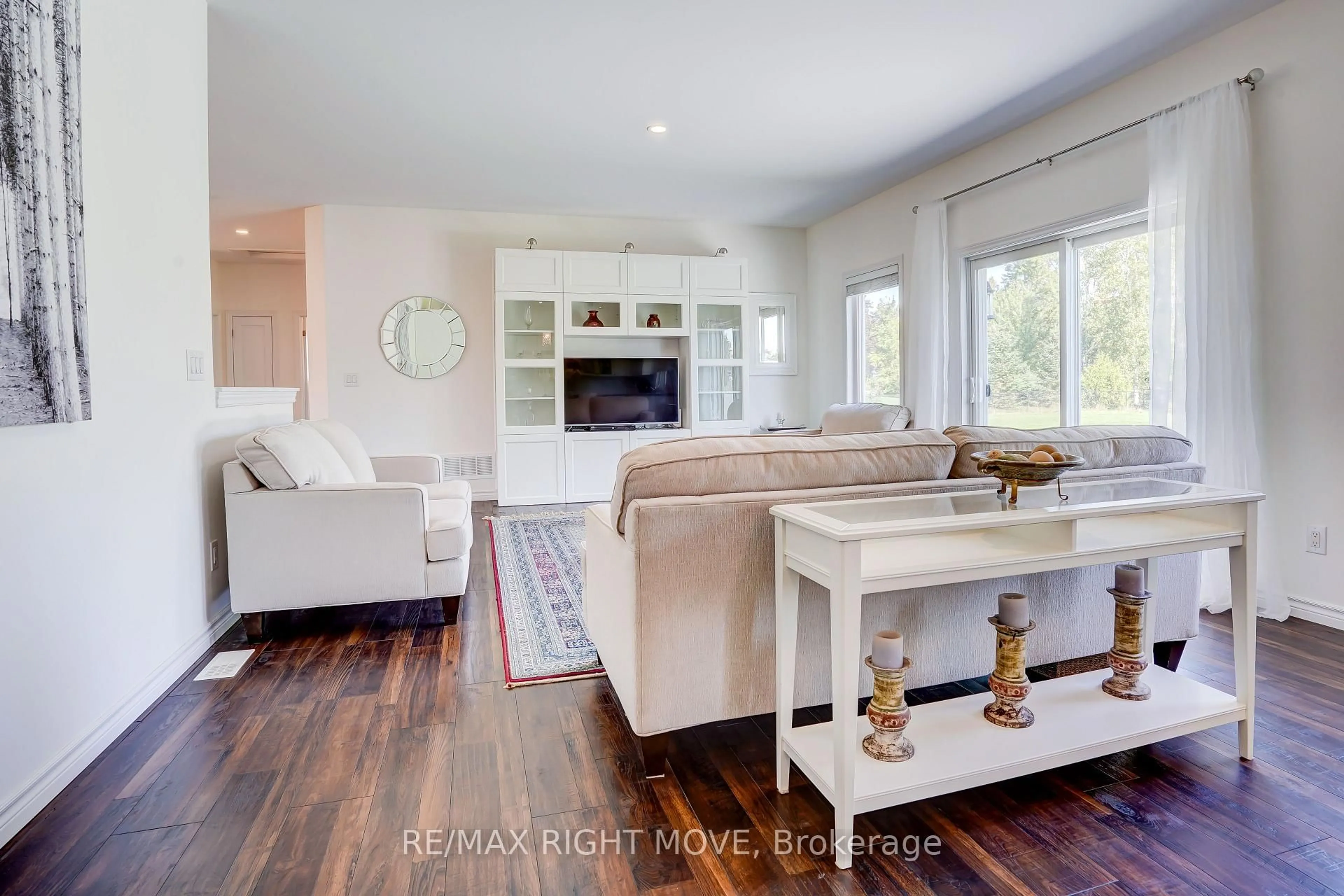 Living room with furniture, wood/laminate floor for 15 Keyzer Dr, Oro-Medonte Ontario L3V 8N7