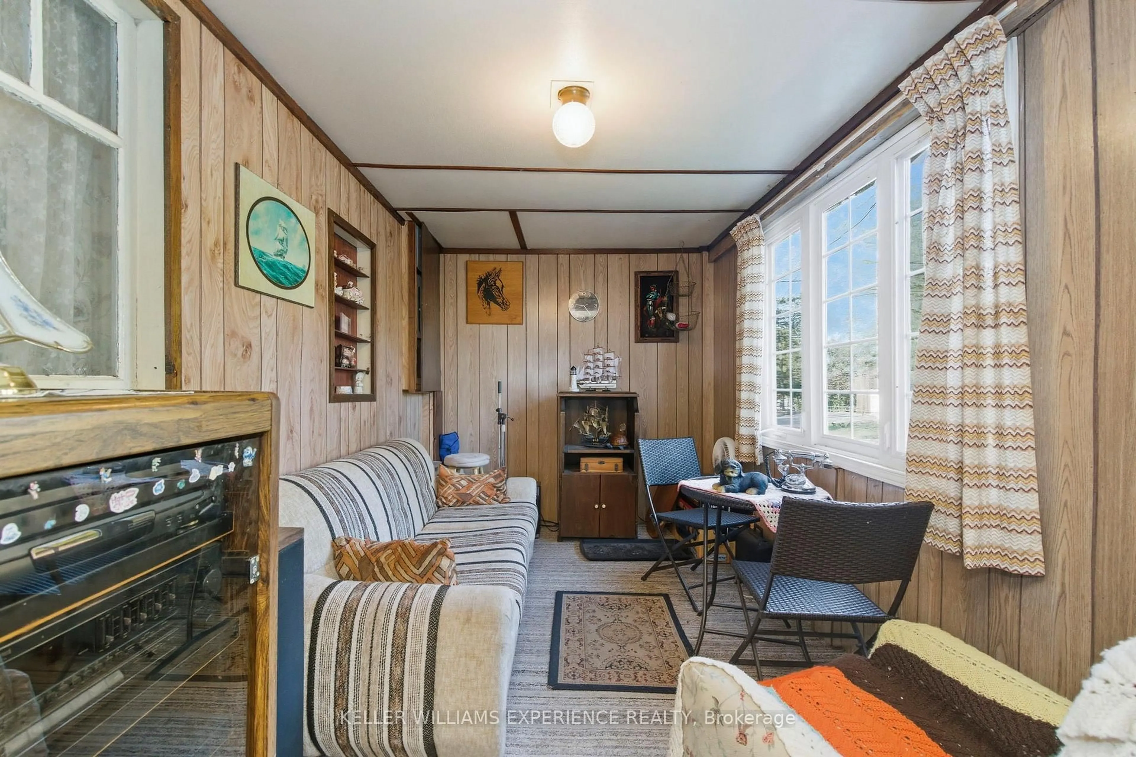 Living room with furniture, wood/laminate floor for 2007 Tiny Beaches Rd, Tiny Ontario L0L 1P1