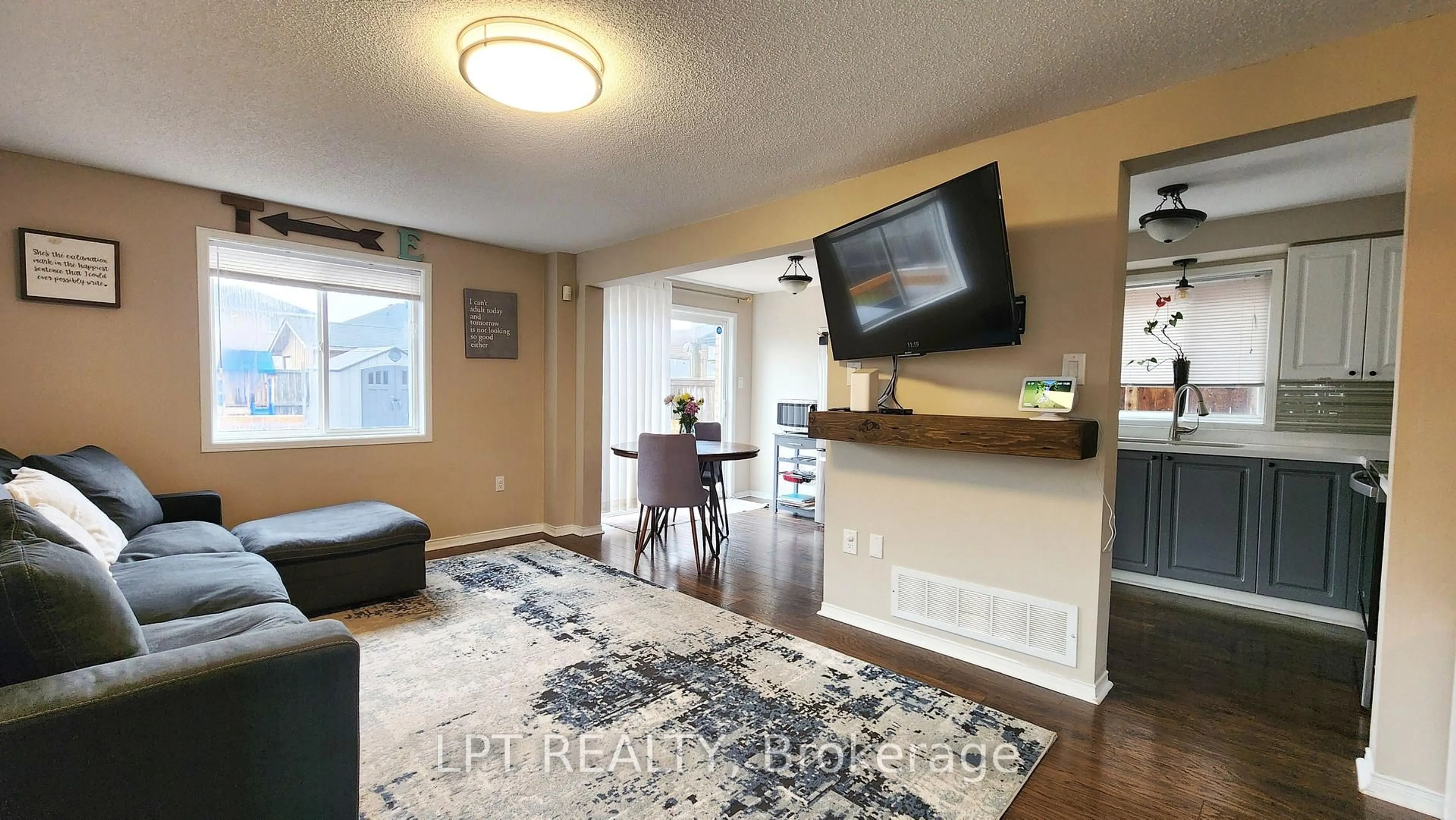 Living room with furniture, wood/laminate floor for 39 Raymond Cres, Barrie Ontario L4N 0X6