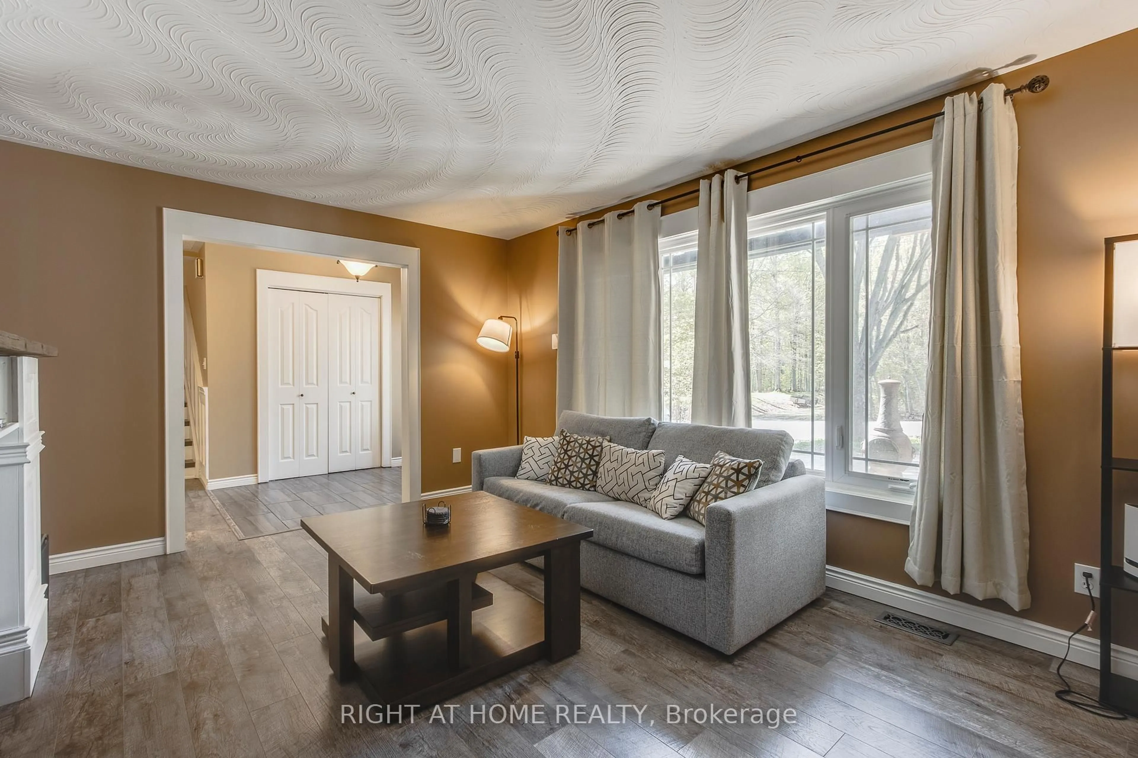 Living room with furniture, wood/laminate floor for 119 Timcourt Dr, Tiny Ontario L9M 0B9