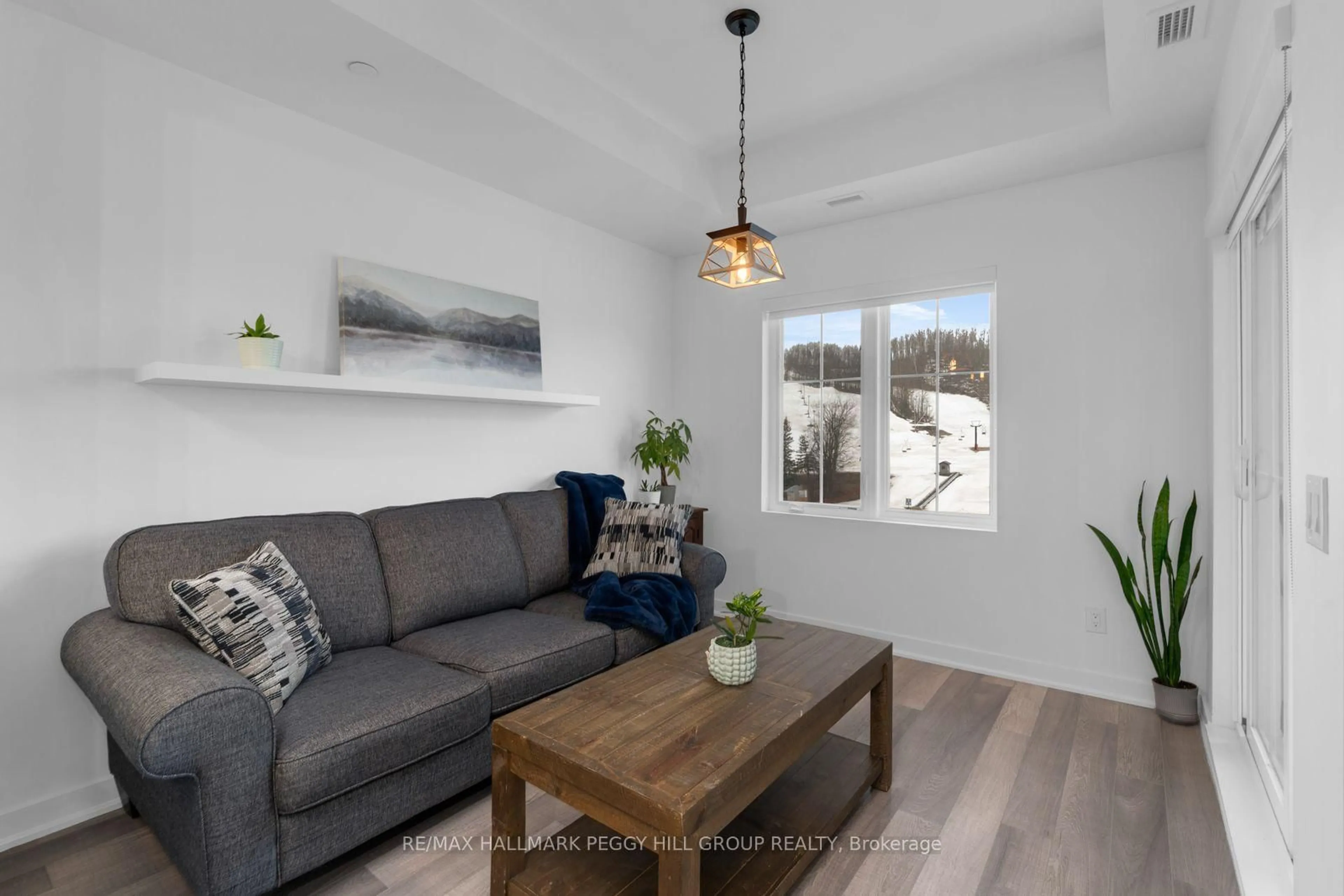 Living room with furniture, wood/laminate floor for 40 Horseshoe Blvd #408, Oro-Medonte Ontario L4M 4Y8