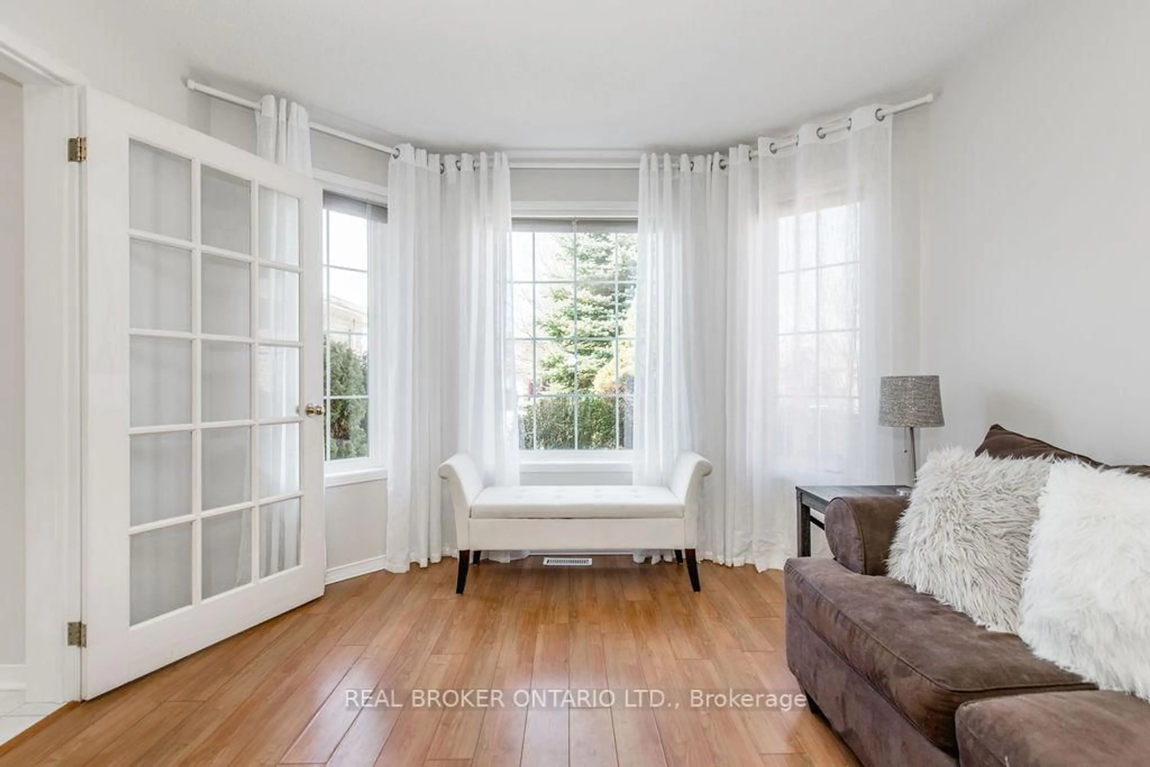 Living room with furniture, wood/laminate floor for 65 Benson Dr, Barrie Ontario L4N 7Y2