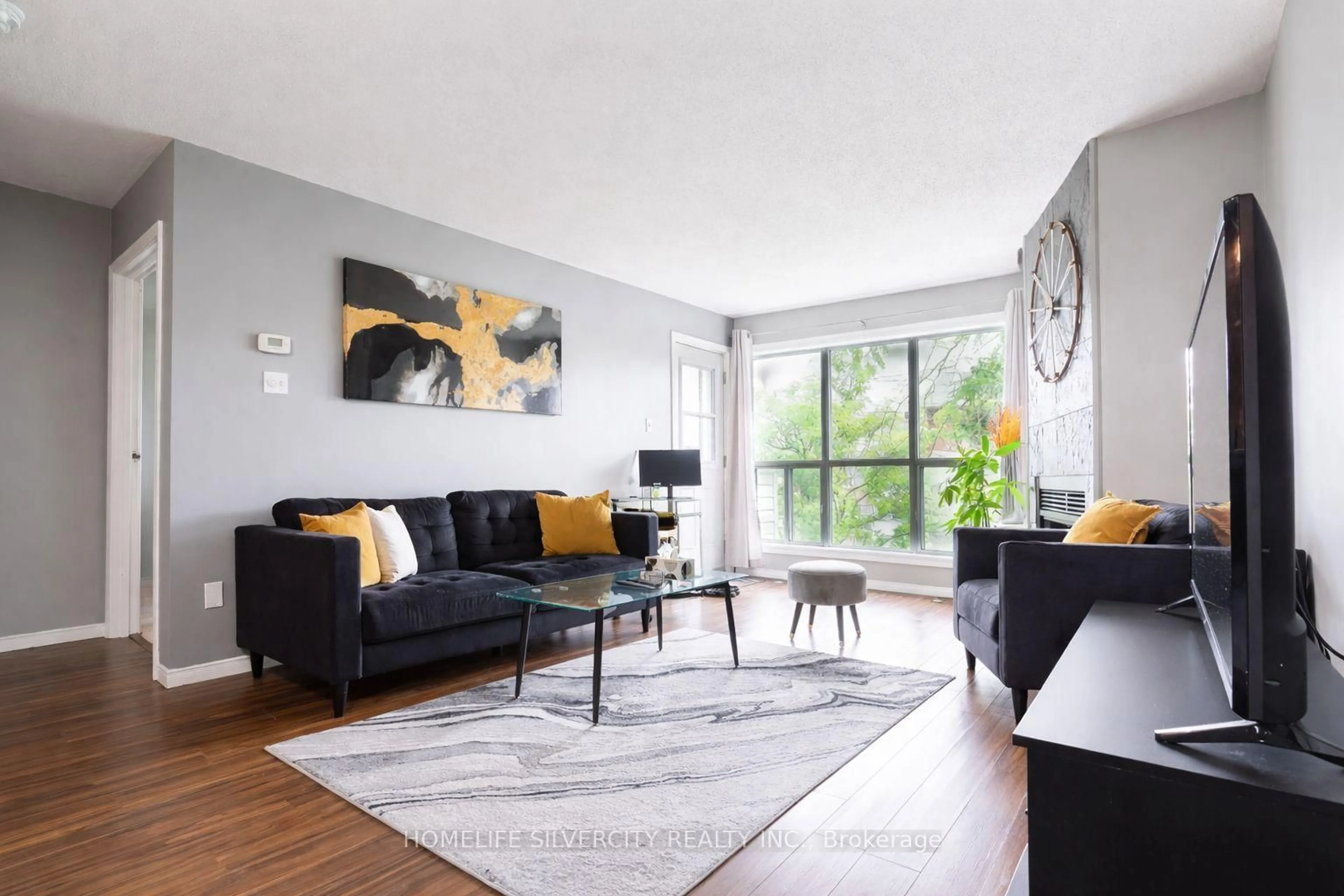 Living room with furniture, wood/laminate floor for 120 Bell Farm Rd #316, Barrie Ontario L4M 6J2