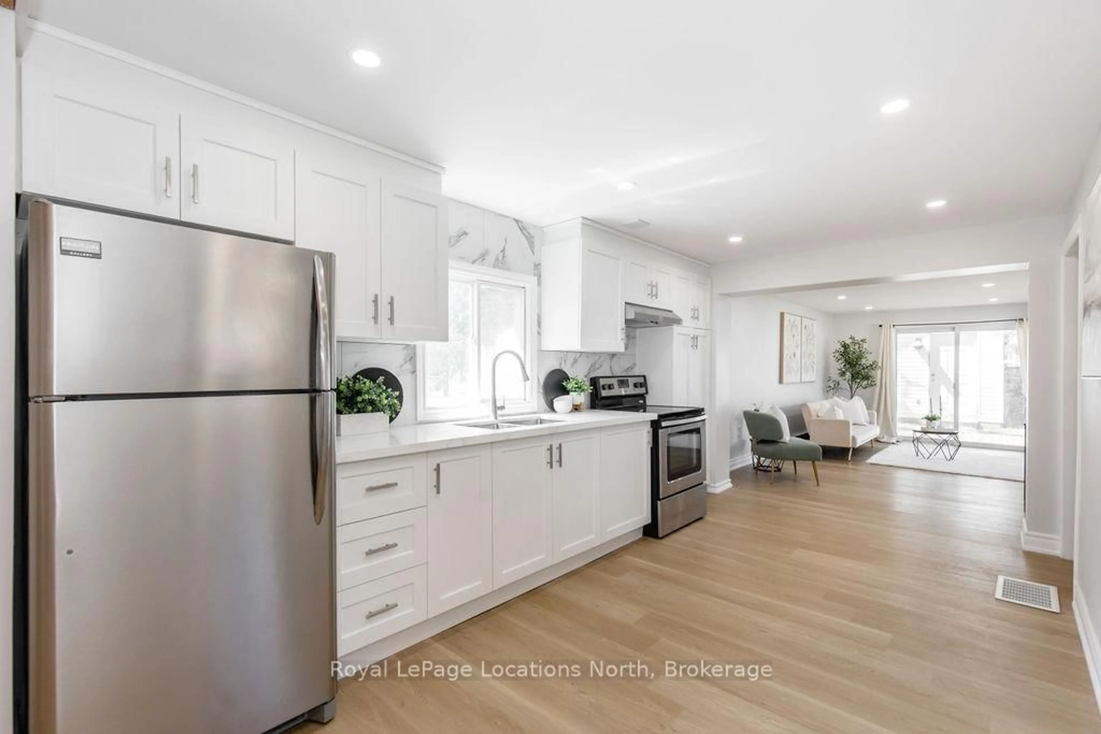 Open concept kitchen, wood/laminate floor for 56 68th St, Wasaga Beach Ontario L9Z 1T8