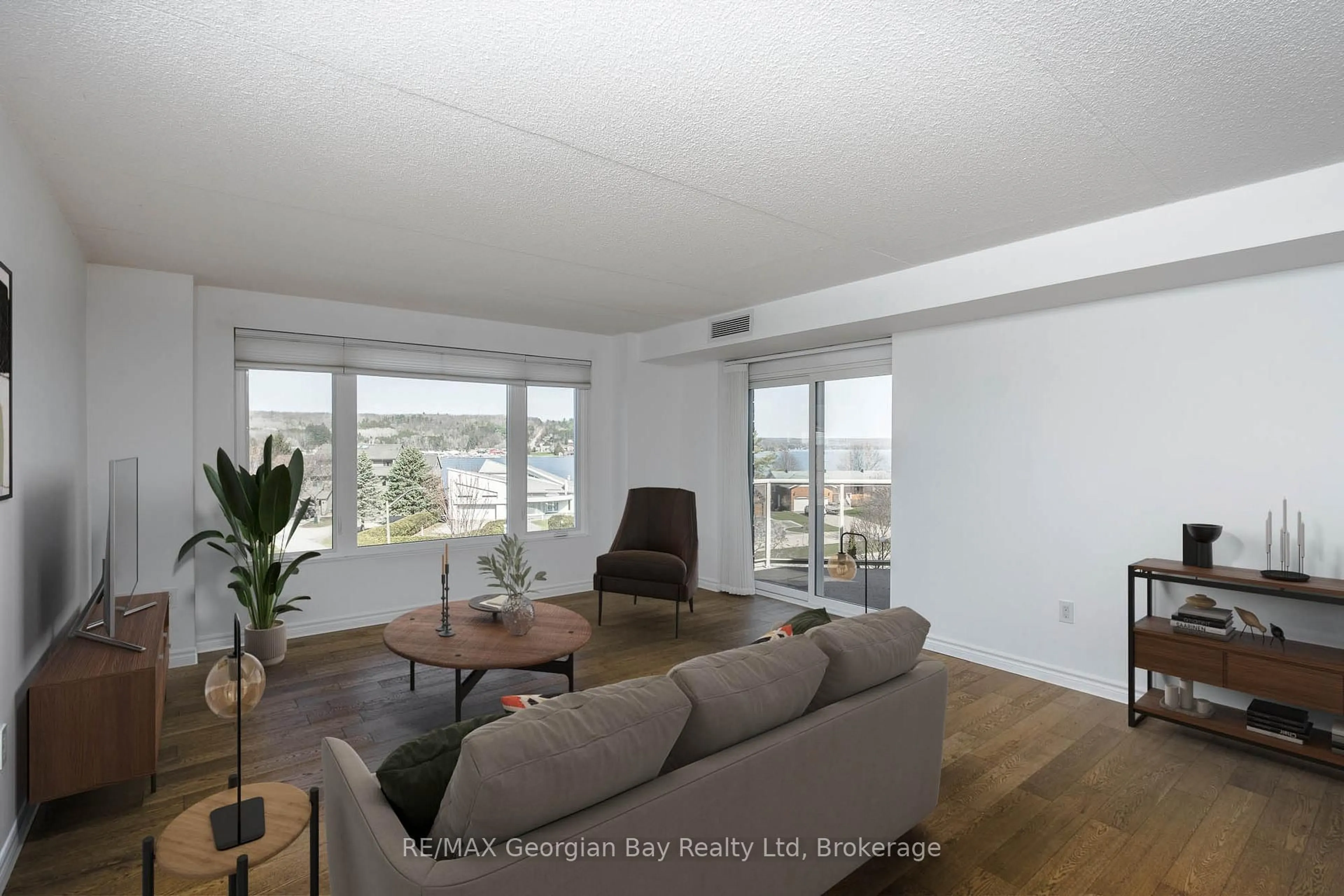 Living room with furniture, wood/laminate floor for 11 Beck Blvd #404, Penetanguishene Ontario L9M 2G1