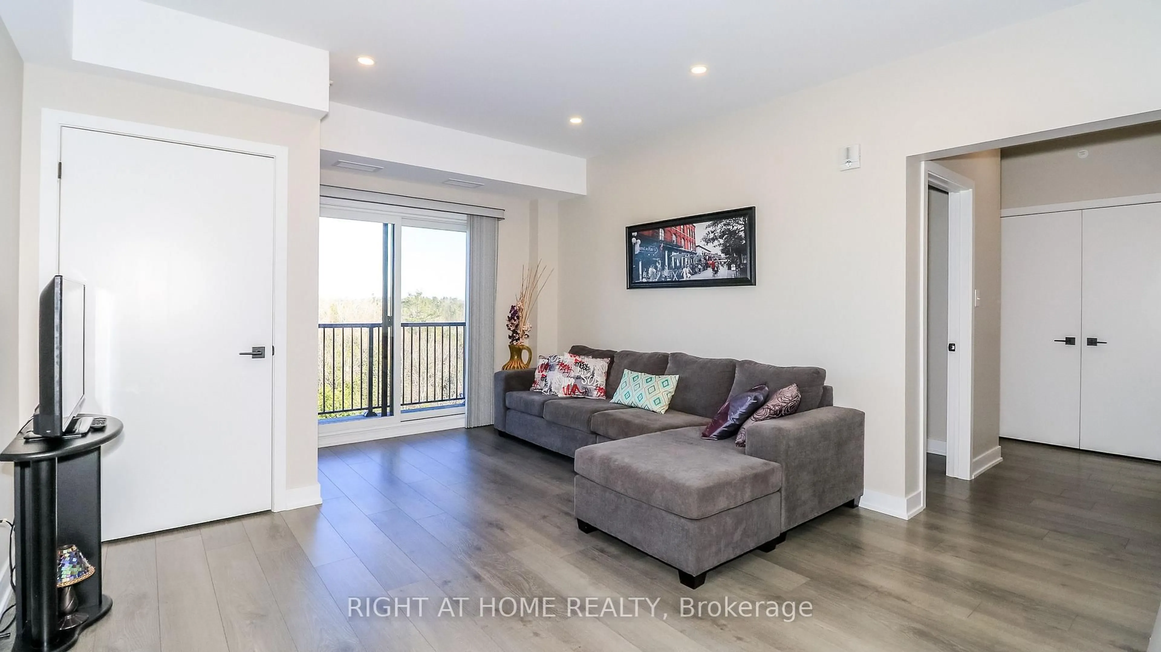 Living room with furniture, wood/laminate floor for 5 Chef Lane #510, Barrie Ontario L9J 0J8