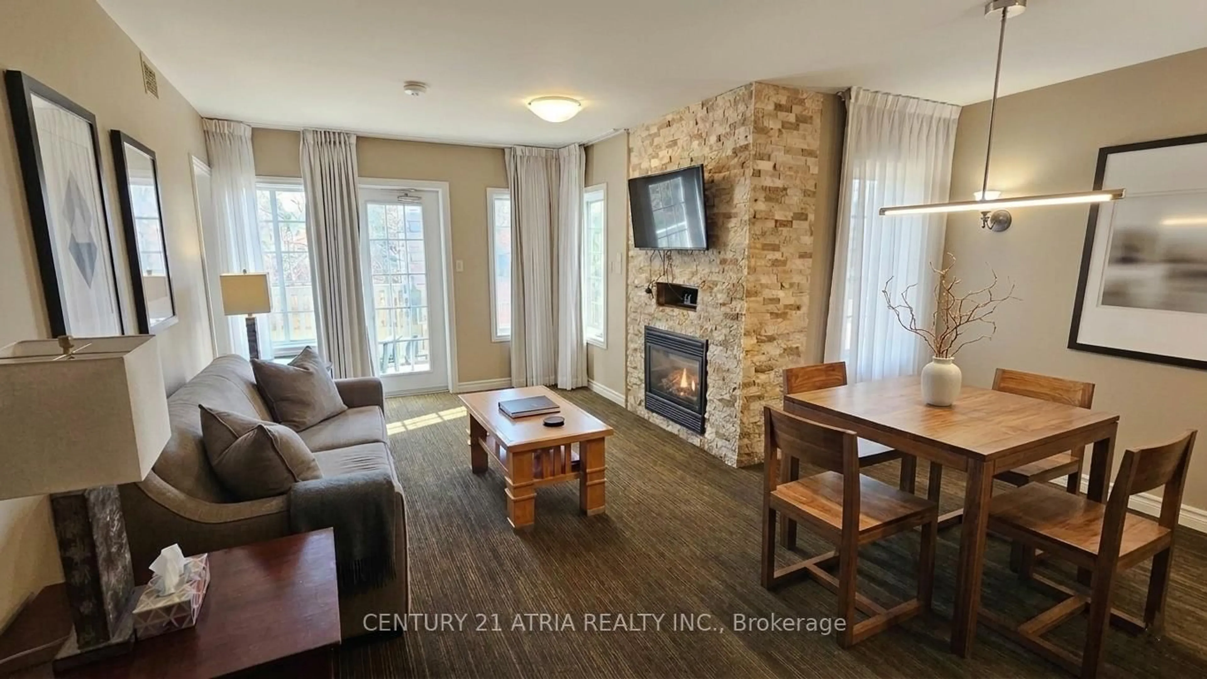 Living room with furniture, wood/laminate floor for 90 Highland Dr #2074, Oro-Medonte Ontario L0L 2L0