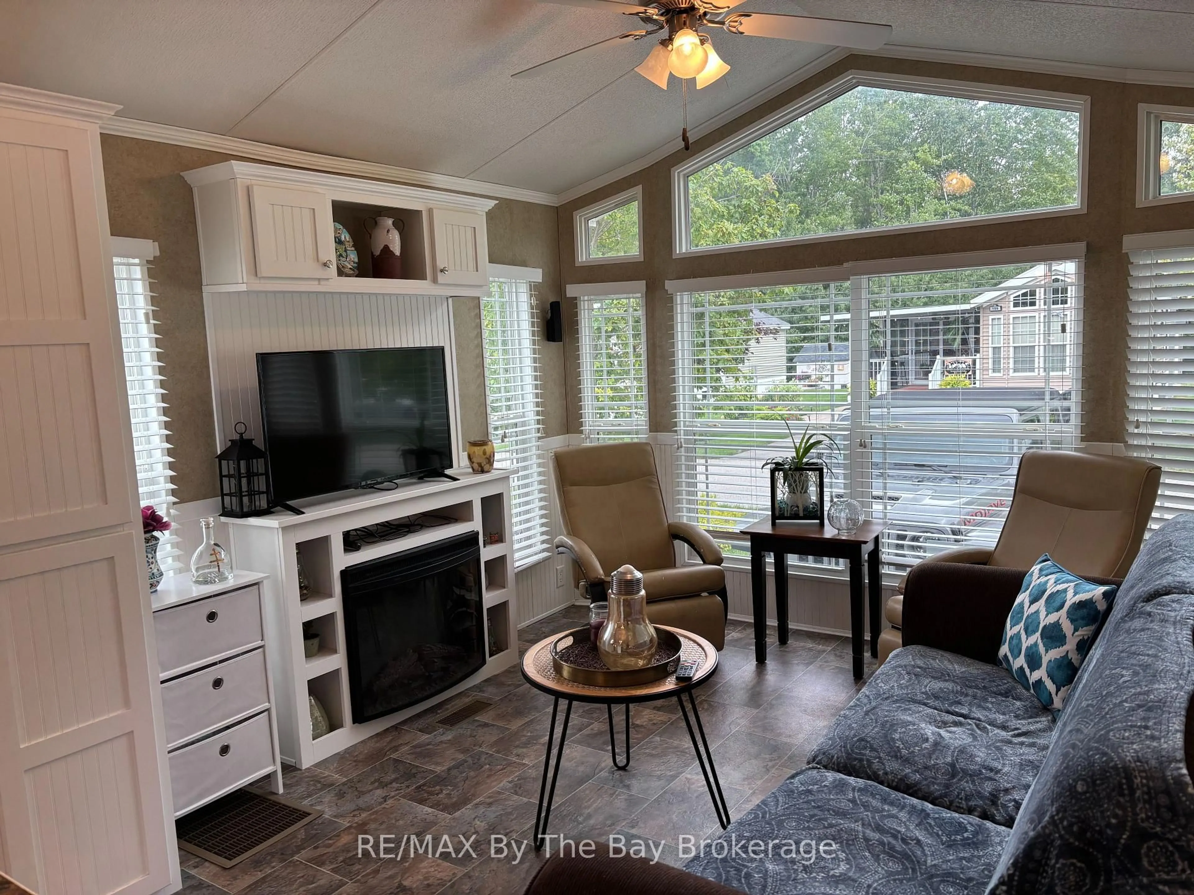 Living room with furniture, wood/laminate floor for 108 Madawaska Tr, Wasaga Beach Ontario L9Z 1X7