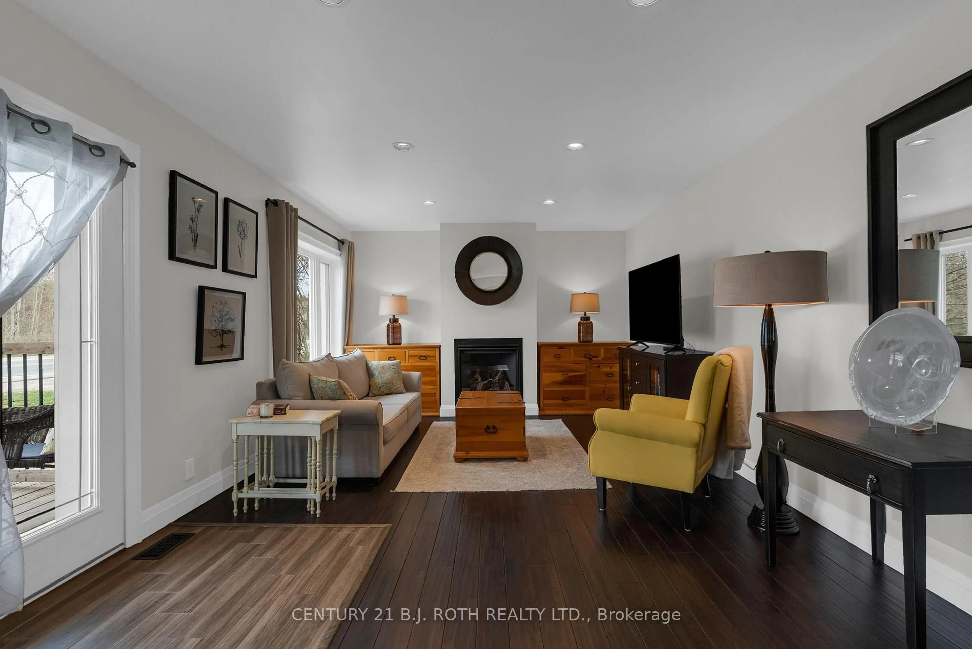 Living room with furniture, wood/laminate floor for 6511 Highway 93, Springwater Ontario L0L 1P0