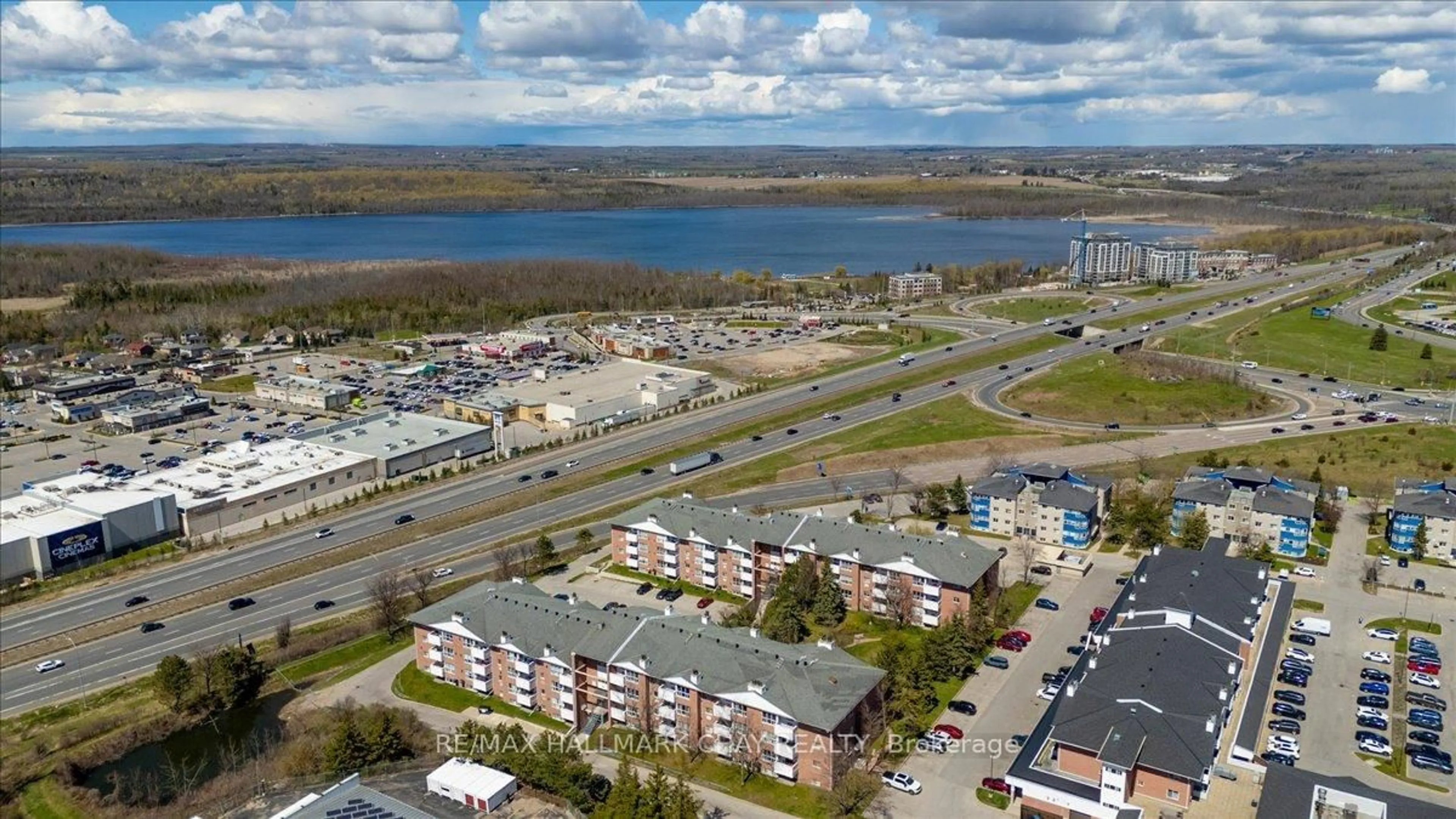 A pic from outside/outdoor area/front of a property/back of a property/a pic from drone, water/lake/river/ocean view for 120 Bell Farm Rd #201, Barrie Ontario L4M 6J2