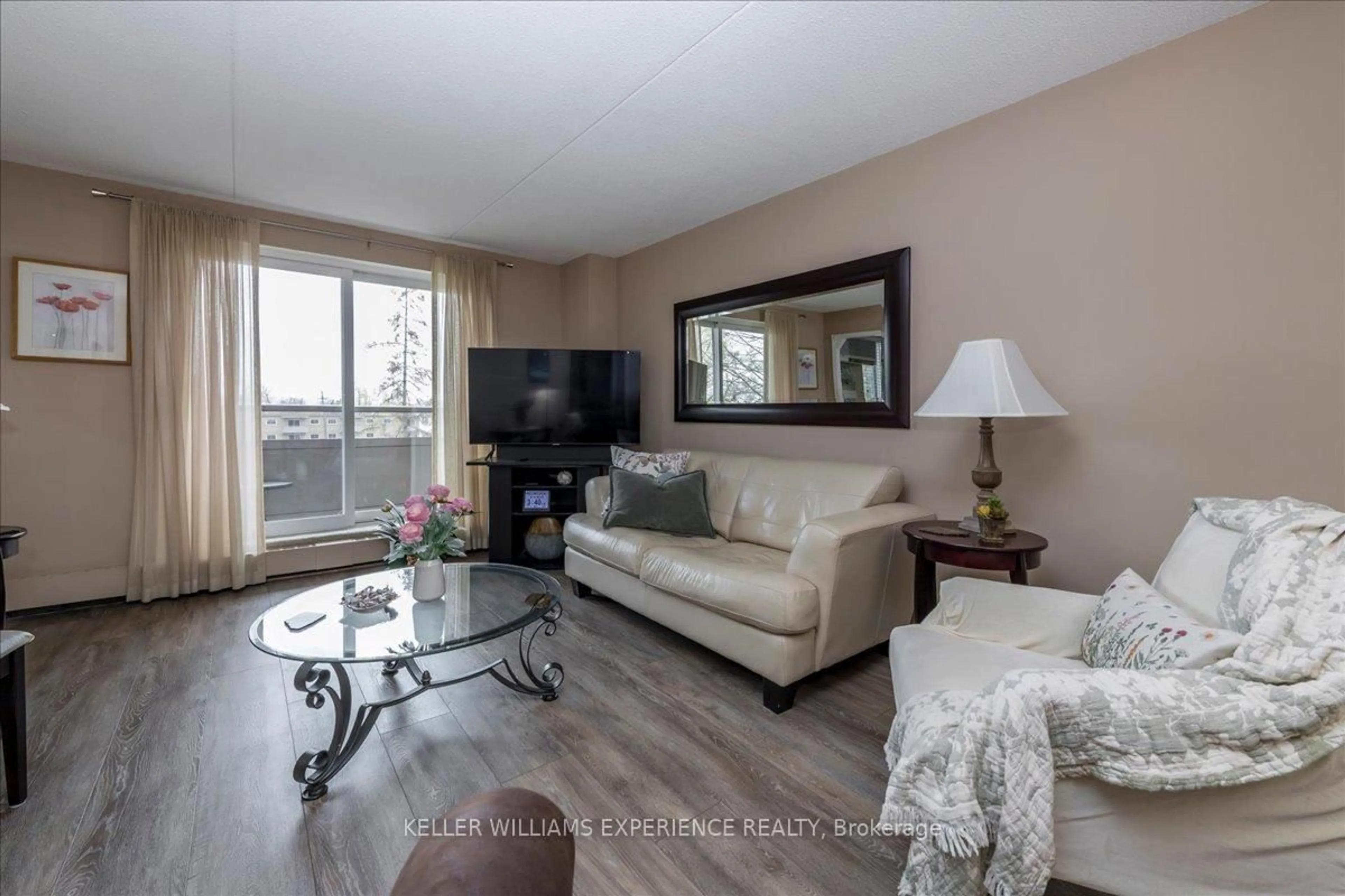 Living room with furniture, wood/laminate floor for 414 Blake St #508, Barrie Ontario L4M 5J7