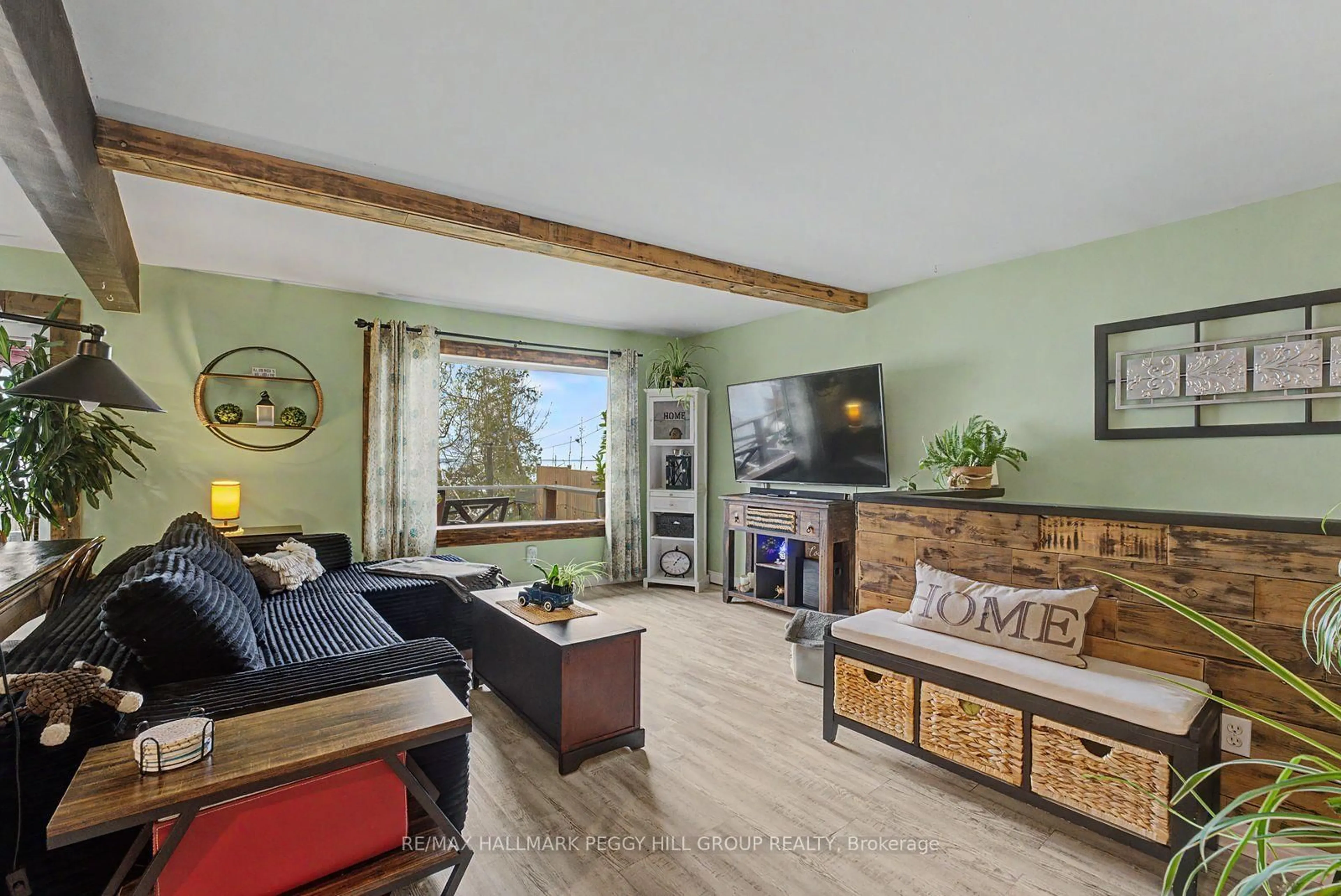 Living room with furniture, wood/laminate floor for 17 Stanley Ave, Oro-Medonte Ontario L0L 1T0