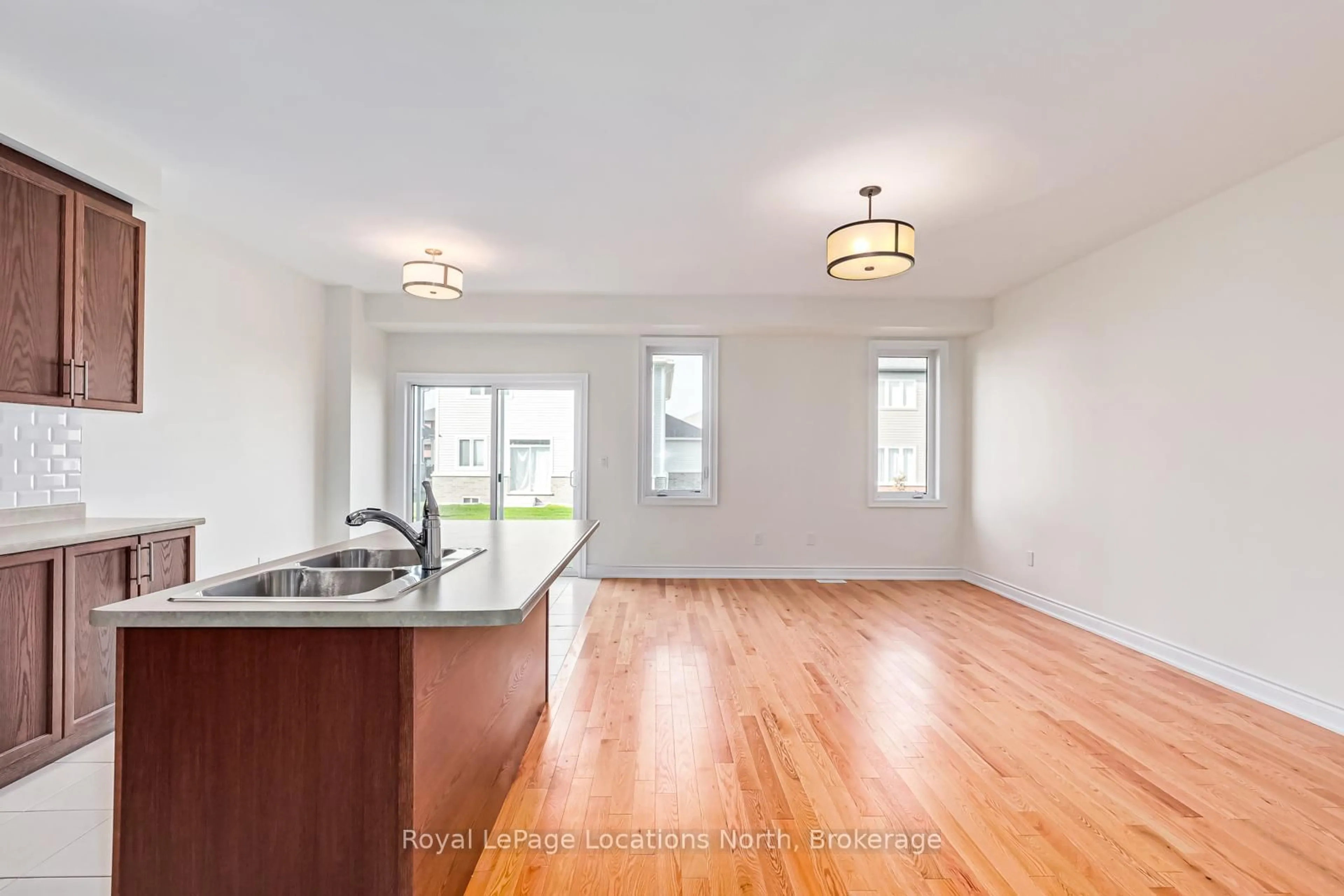 Open concept kitchen, wood/laminate floor for 24 LISA St, Wasaga Beach Ontario L9Y 0K8