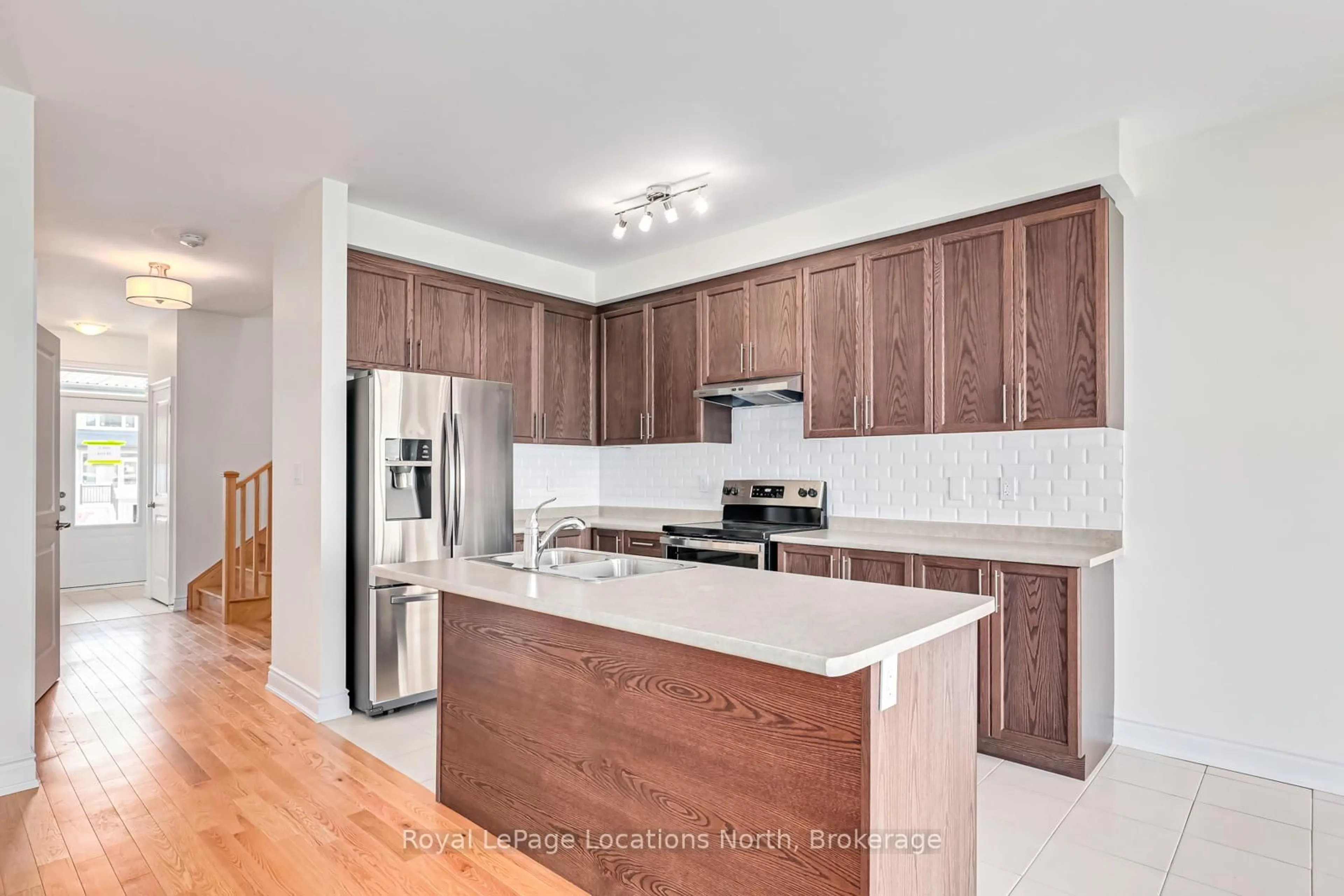 Open concept kitchen, wood/laminate floor for 24 LISA St, Wasaga Beach Ontario L9Y 0K8