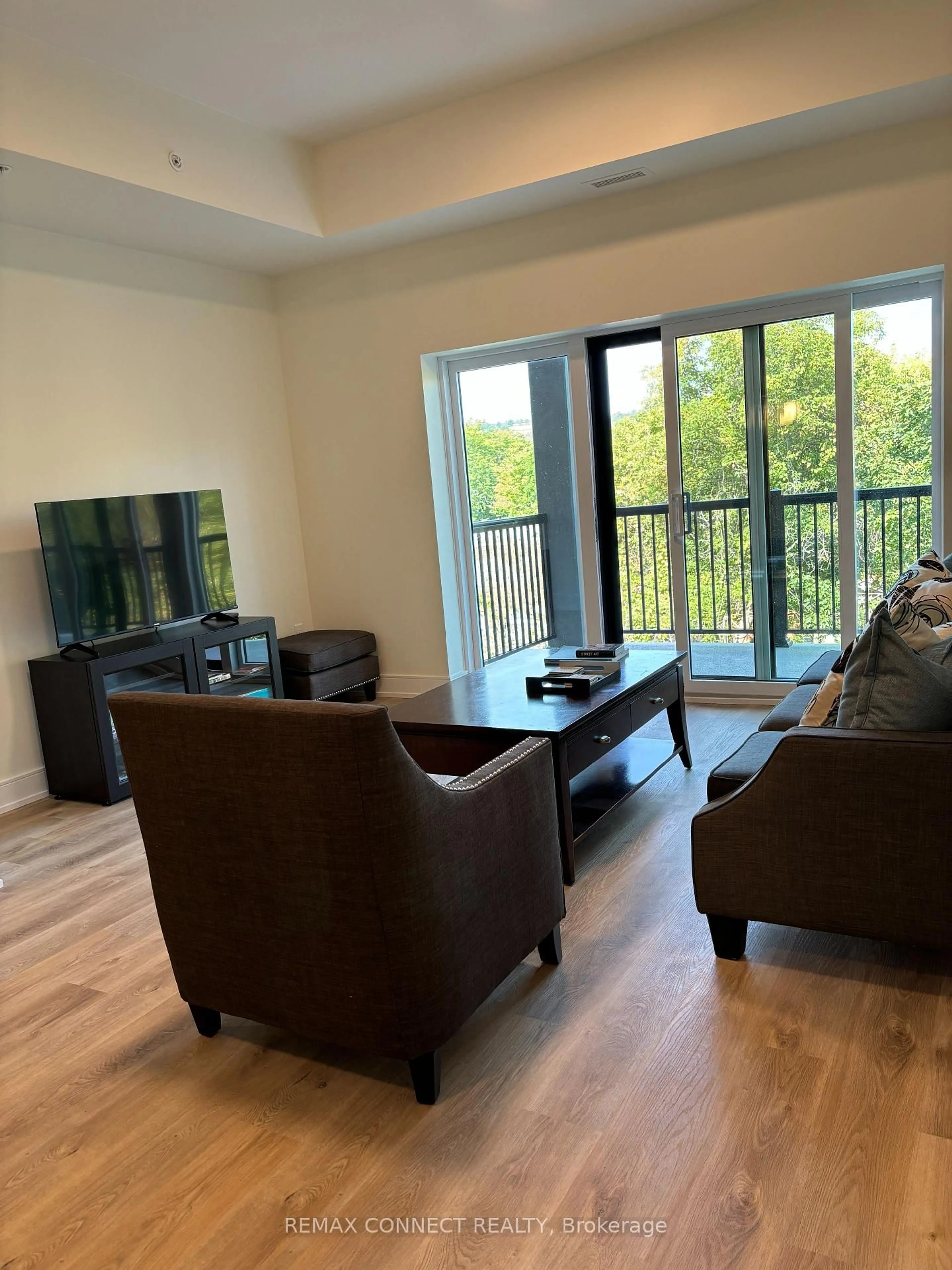 Living room with furniture, wood/laminate floor for 121 Mary St #310, Clearview Ontario L0M 1G0