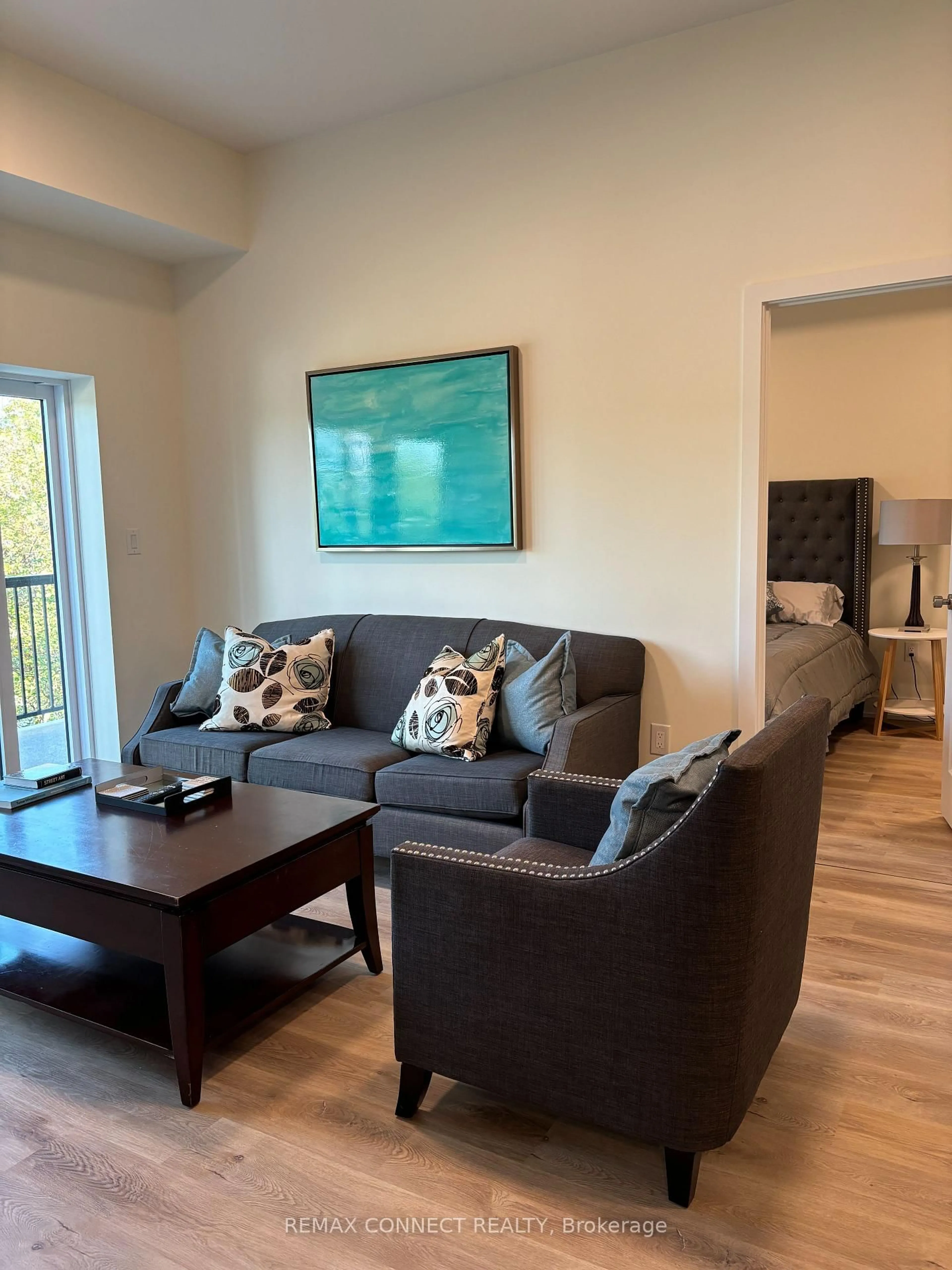 Living room with furniture, wood/laminate floor for 121 Mary St #310, Clearview Ontario L0M 1G0