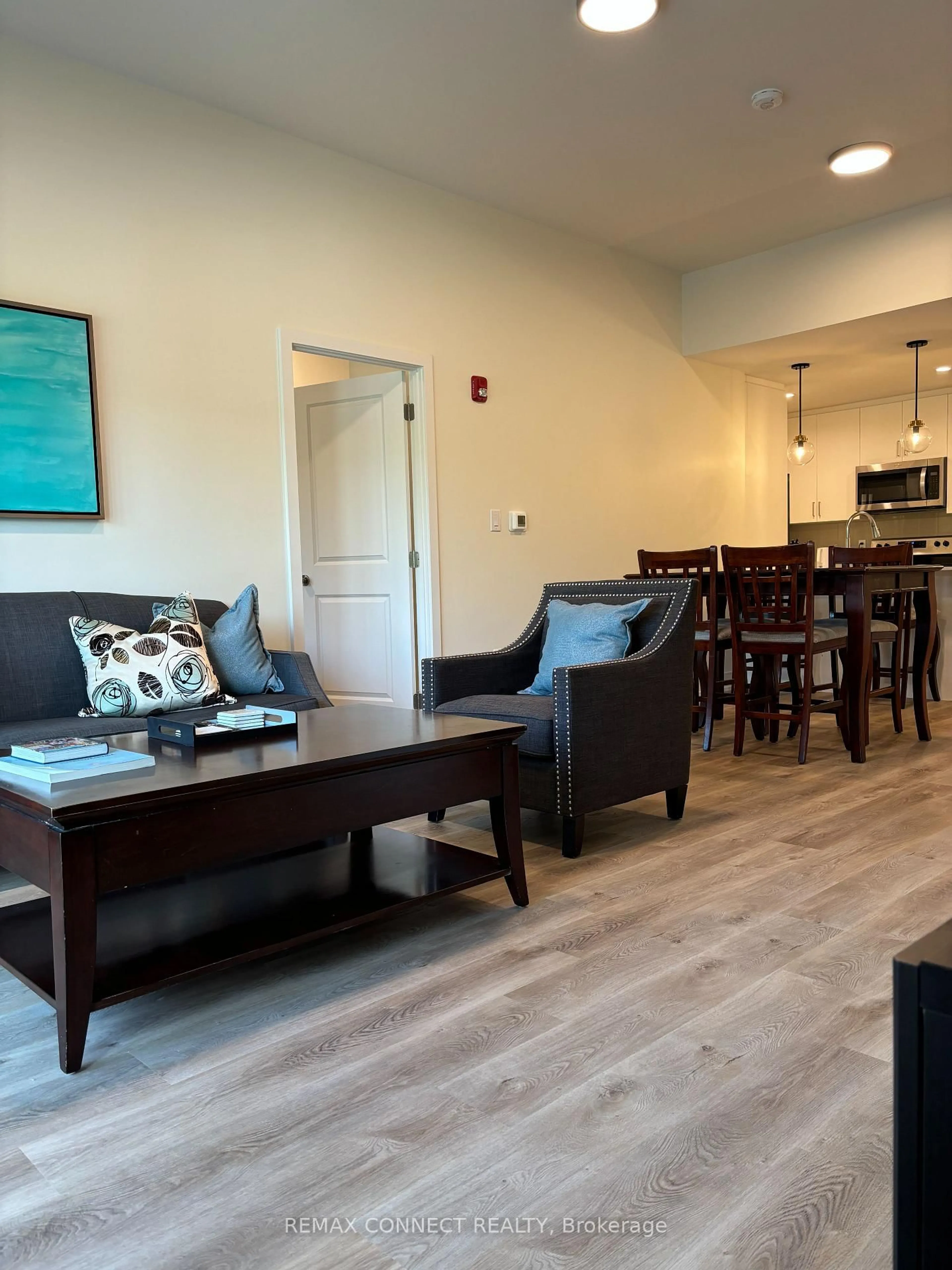 Living room with furniture, wood/laminate floor for 121 Mary St #310, Clearview Ontario L0M 1G0